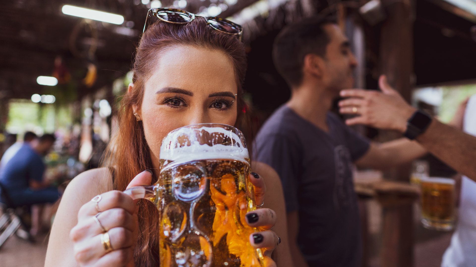 woman in black long sleeve shirt holding drinking glass