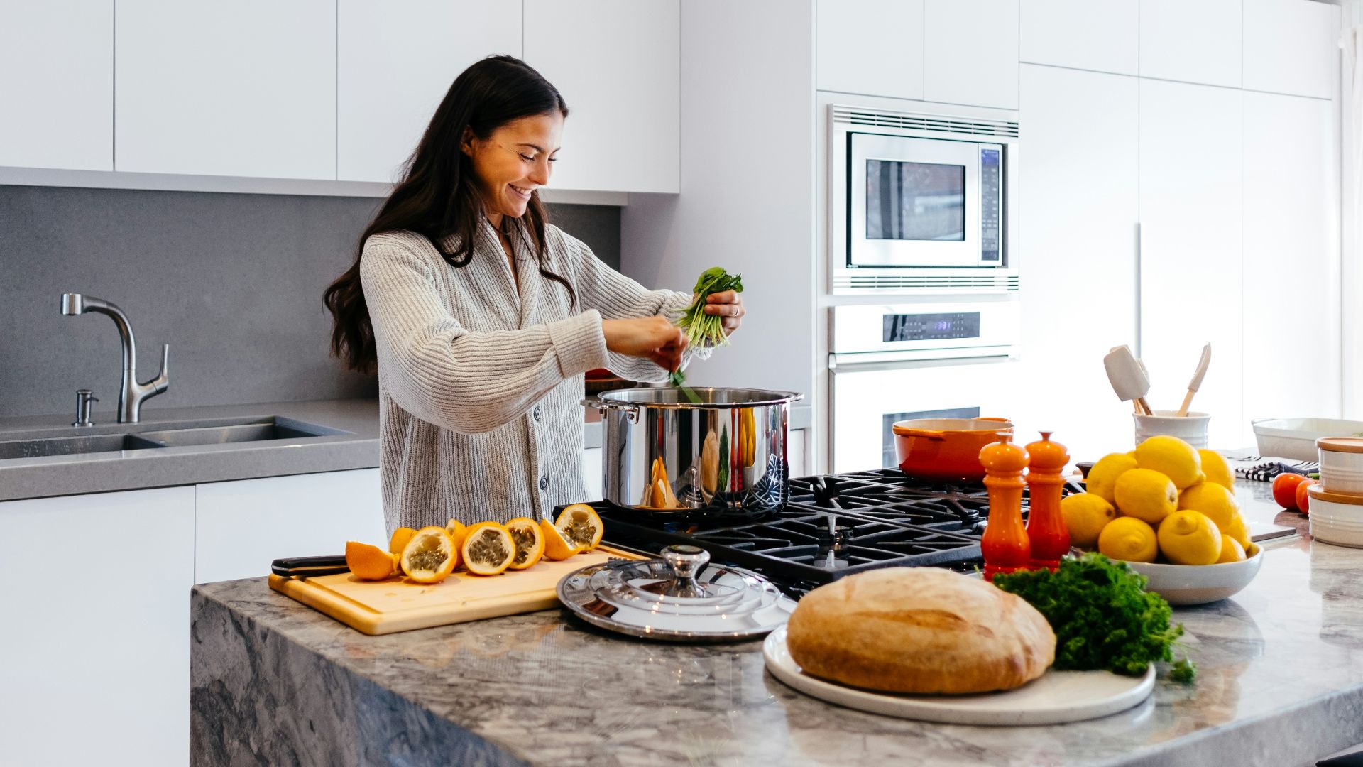 woman smiling while cooking