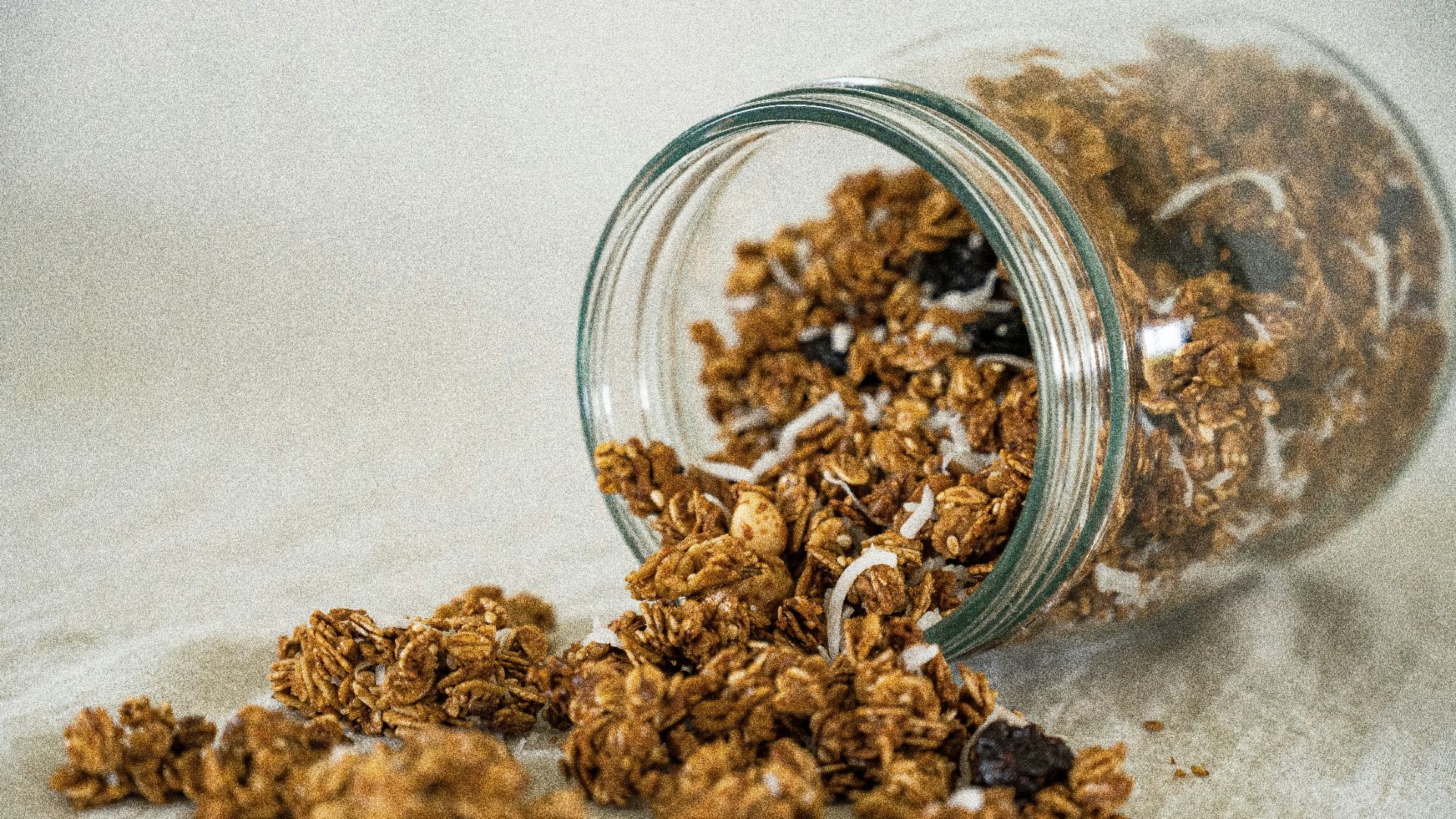 a glass bowl full of dried brown and white grains