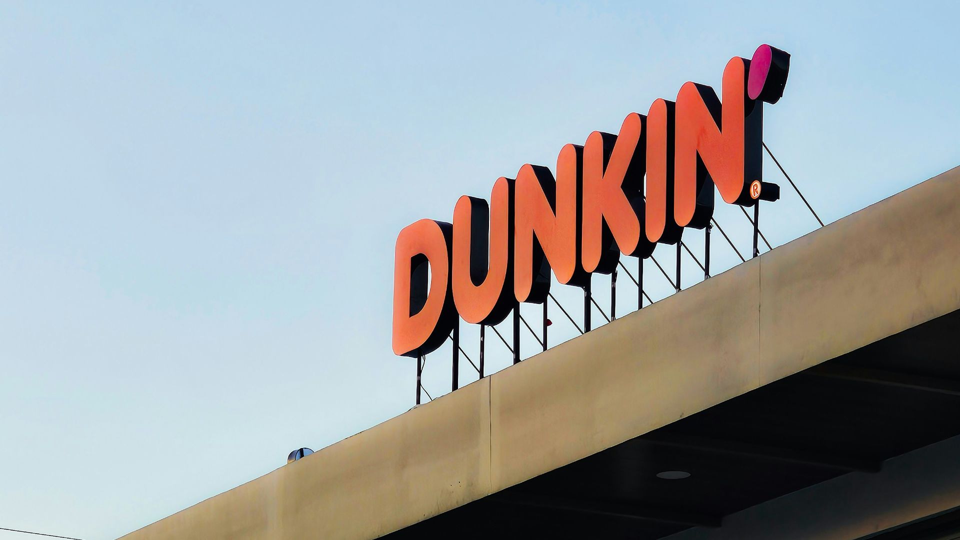a dunkin'donuts sign on top of a building