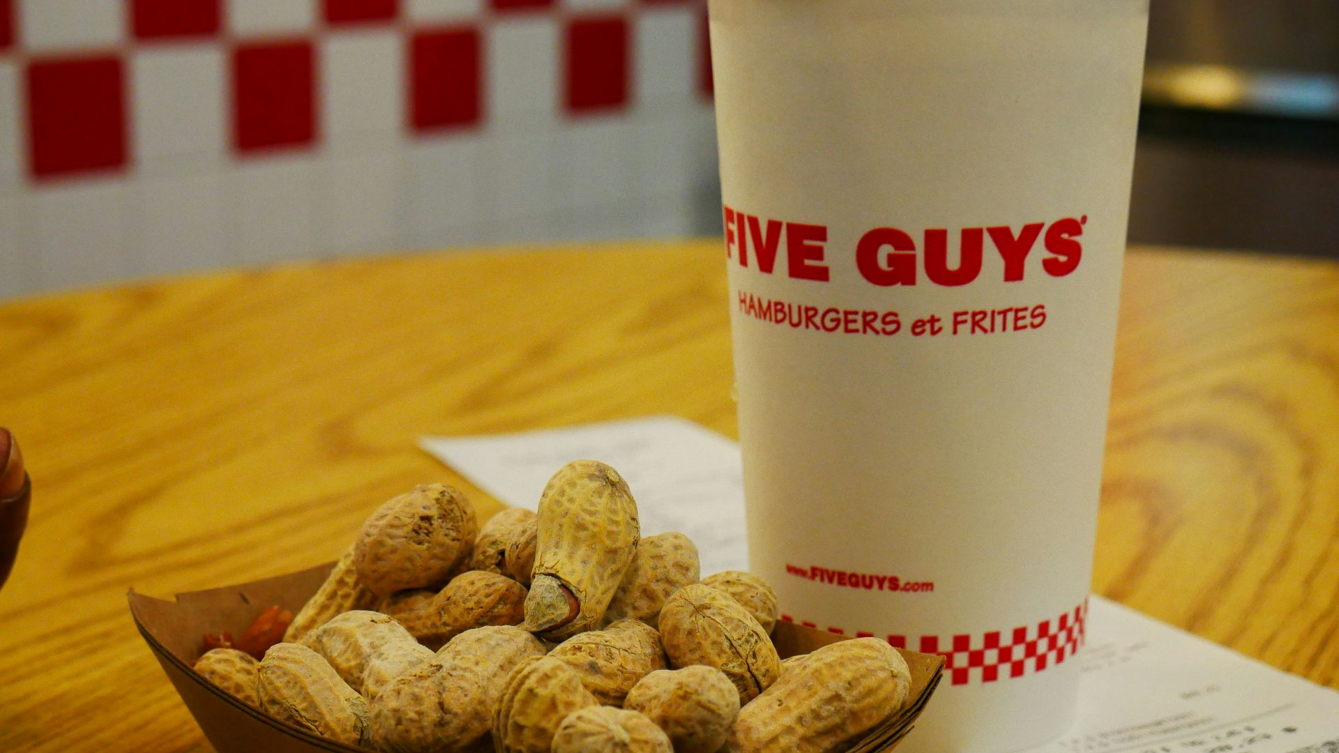 white dunkin donuts disposable cup on brown wooden table