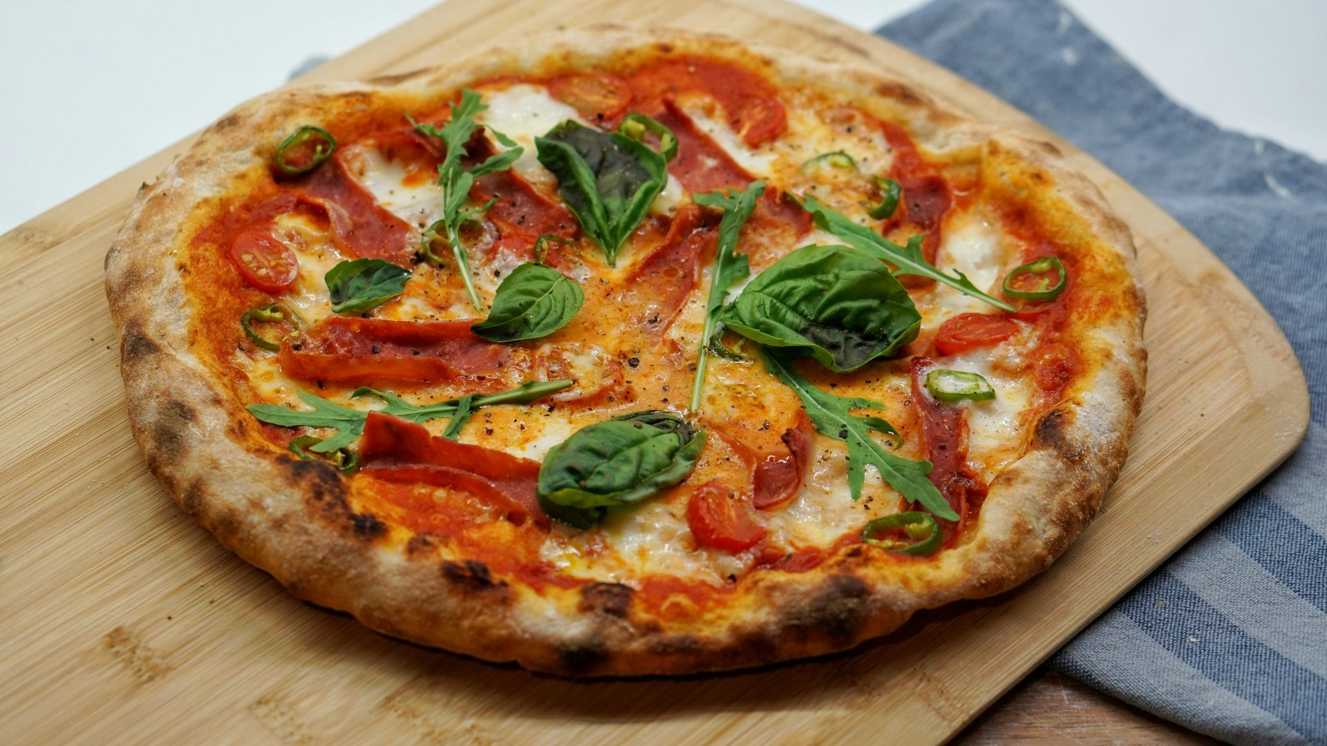 pizza with green leaves and red sauce
