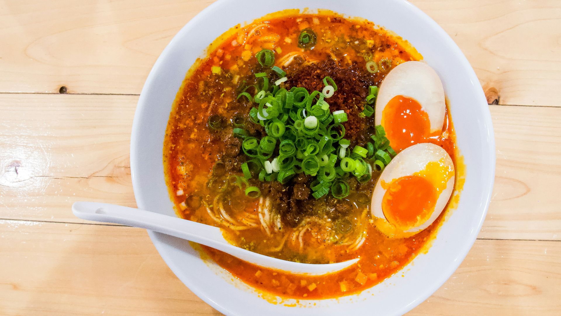 a bowl of soup with an egg on top