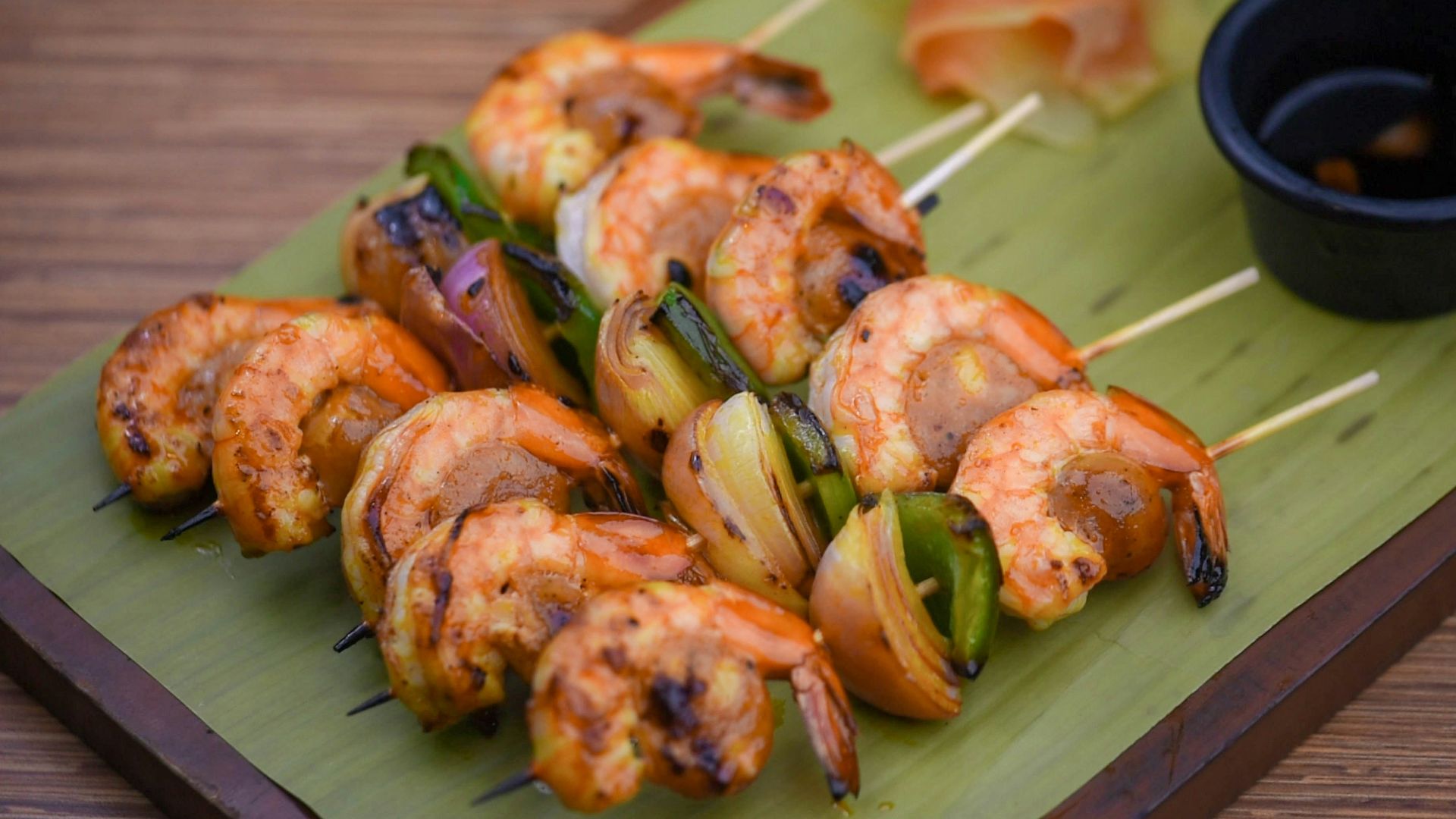 a green plate topped with shrimp and veggies