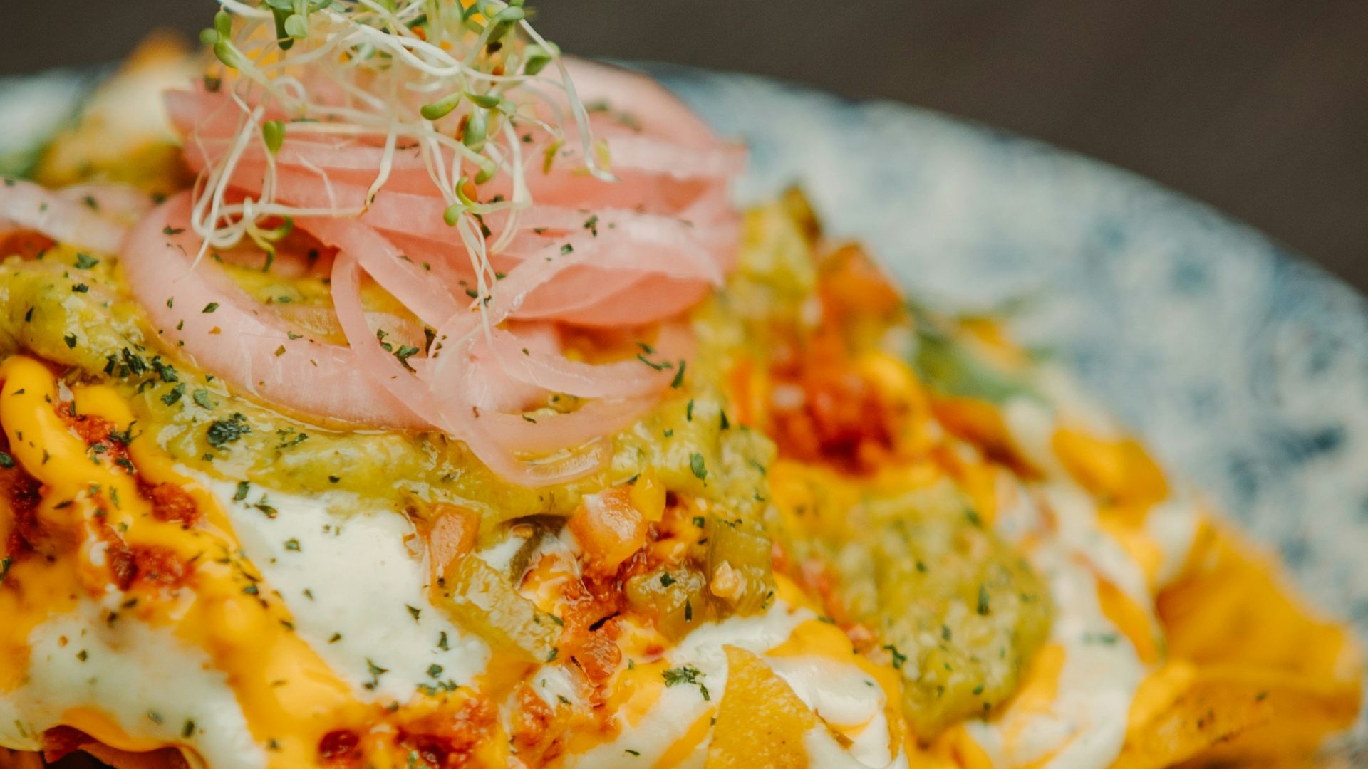 a plate of nachos on a wooden table
