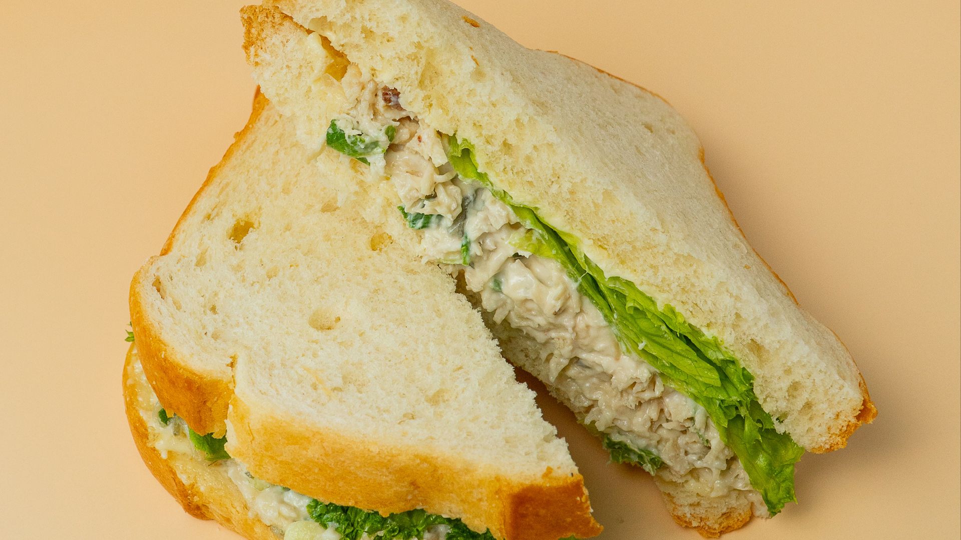 Chicken salad sandwich with lettuce on white bread