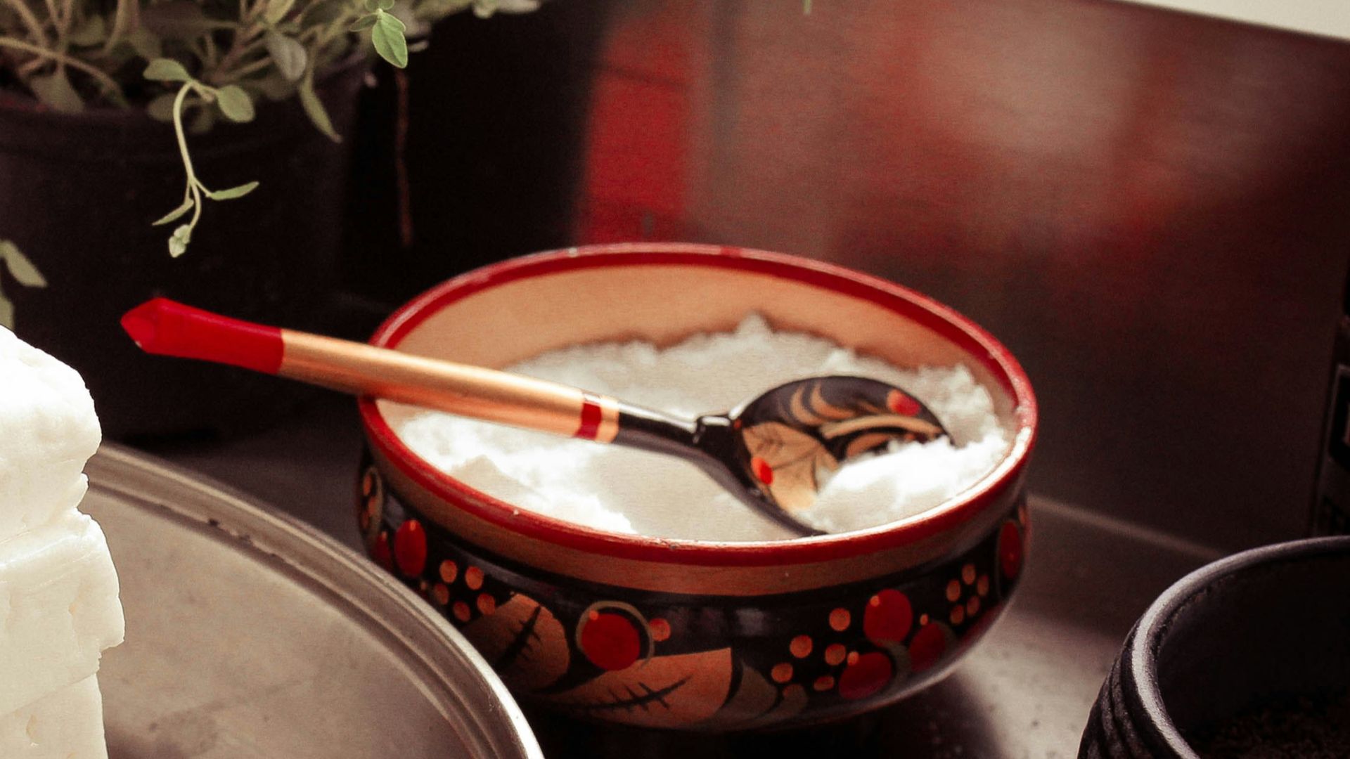 red ceramic bowl on gray spoon