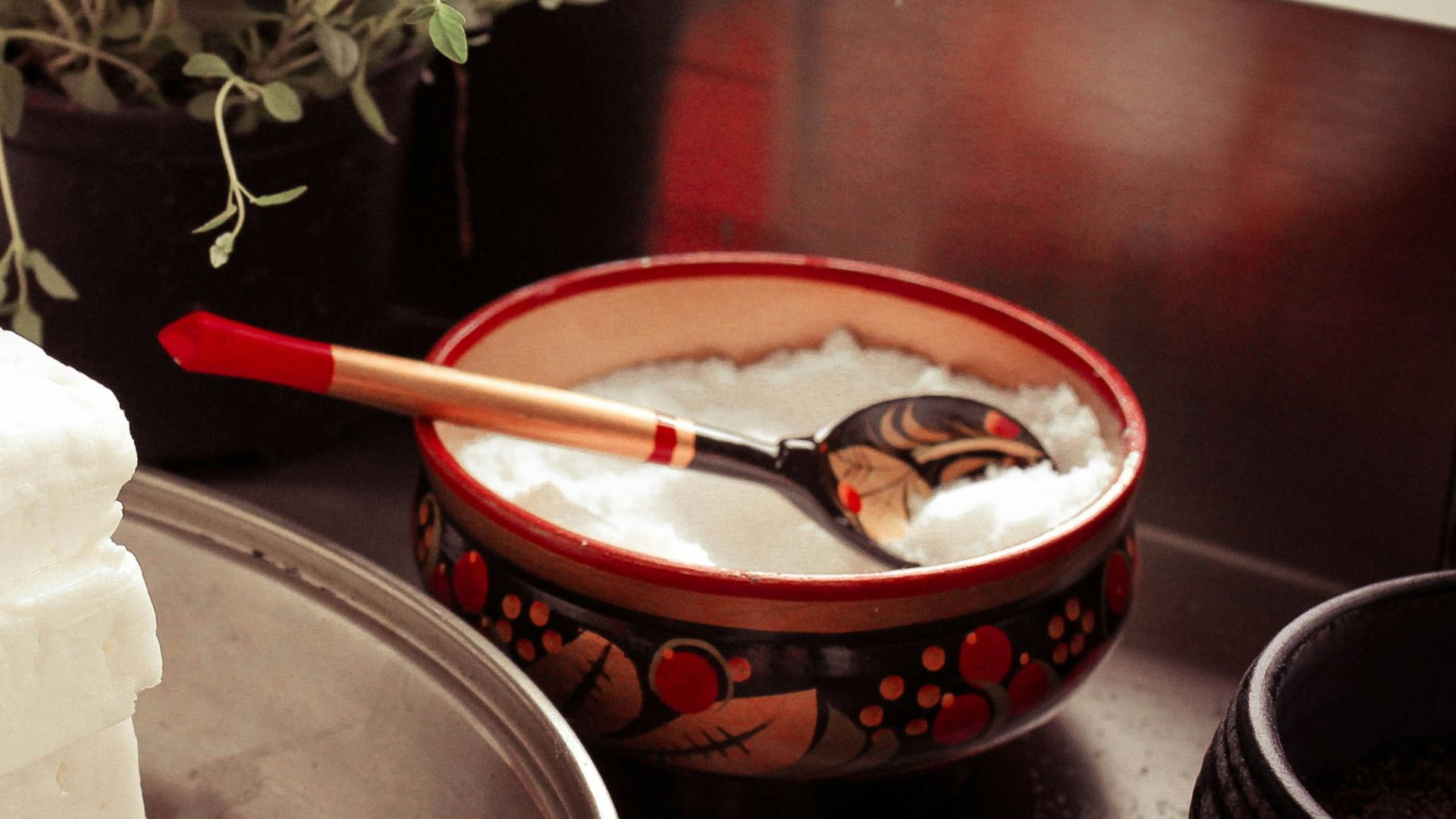 red ceramic bowl on gray spoon