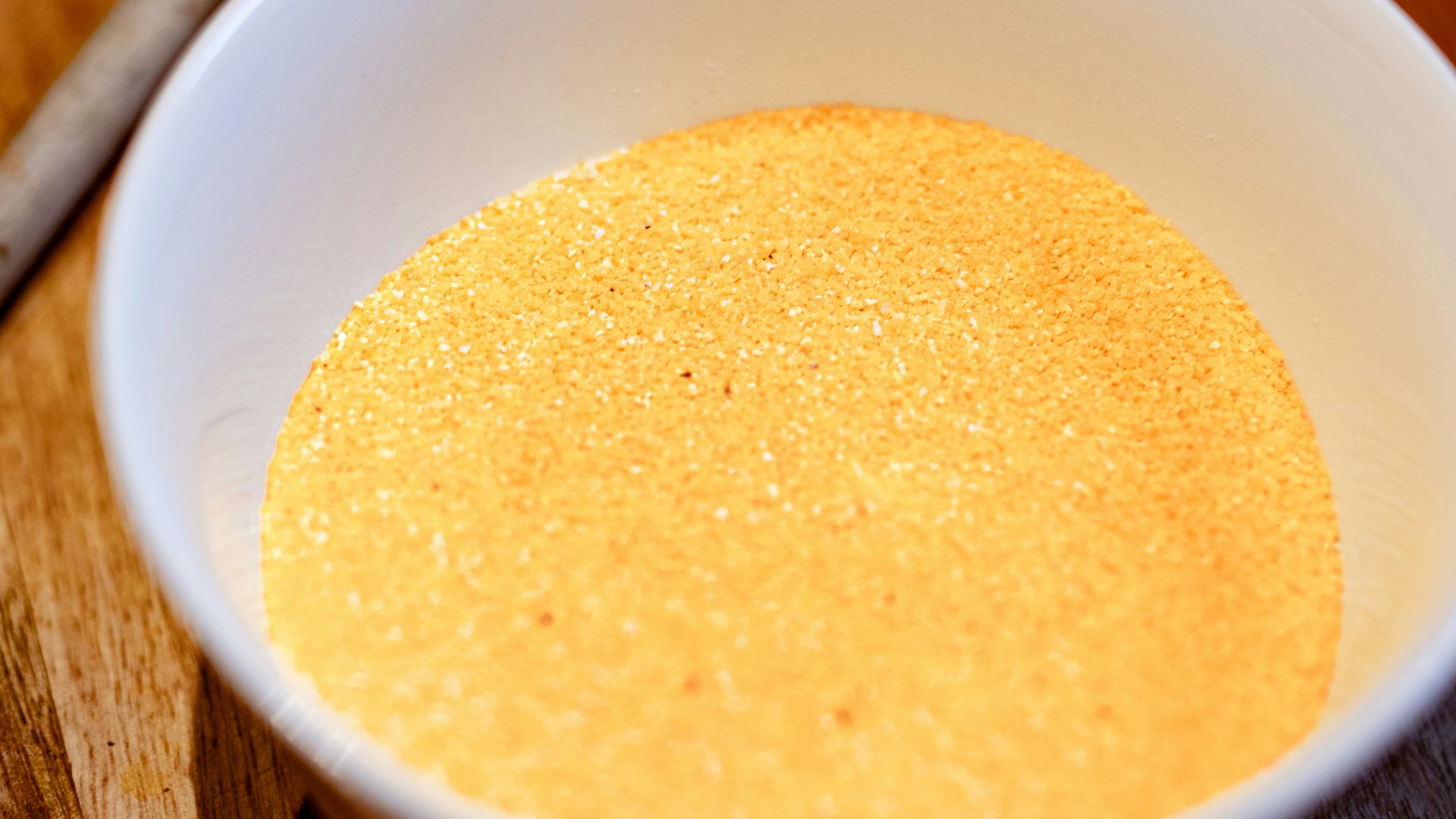 a bowl of soup on a cutting board with a spoon