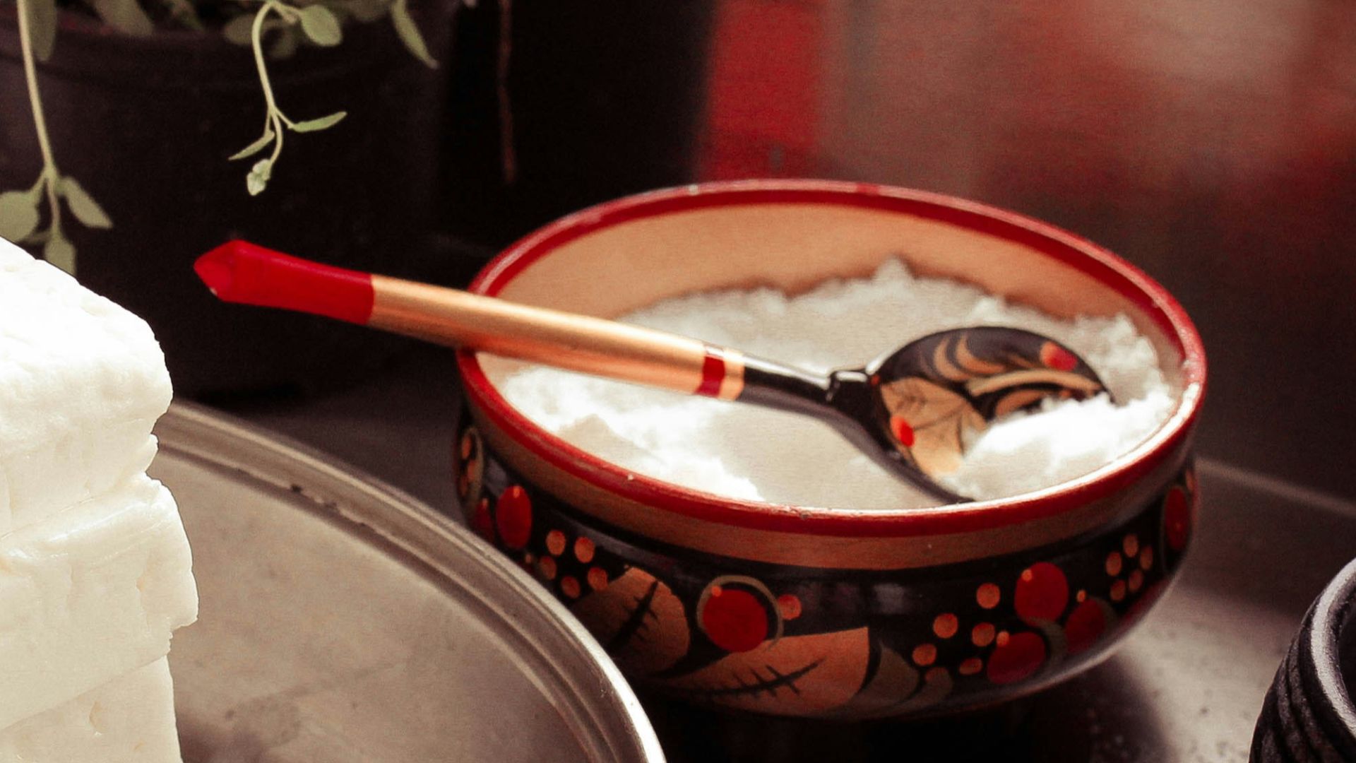 red ceramic bowl on gray spoon