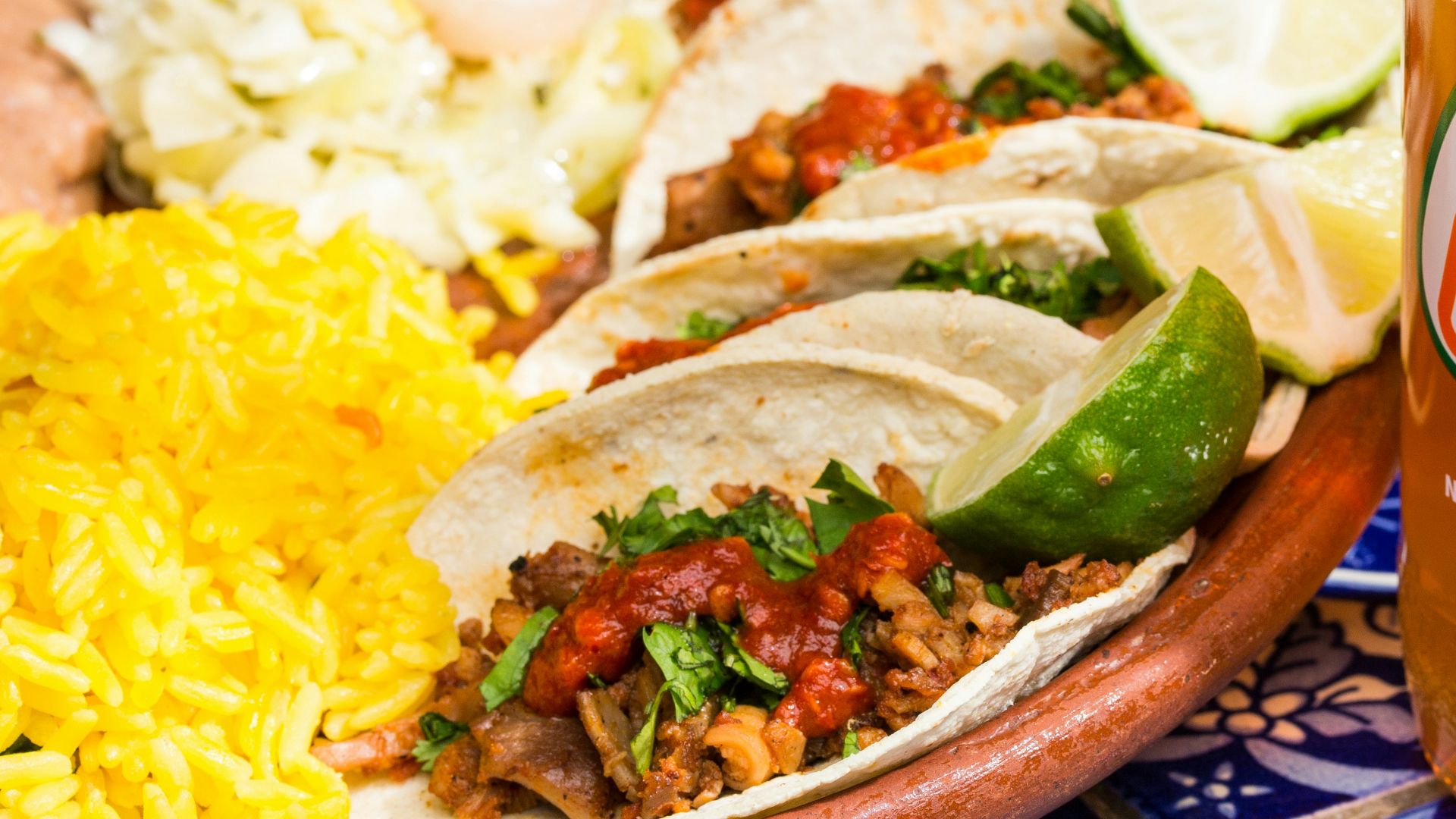 a plate of food and a bottle of beer on a table