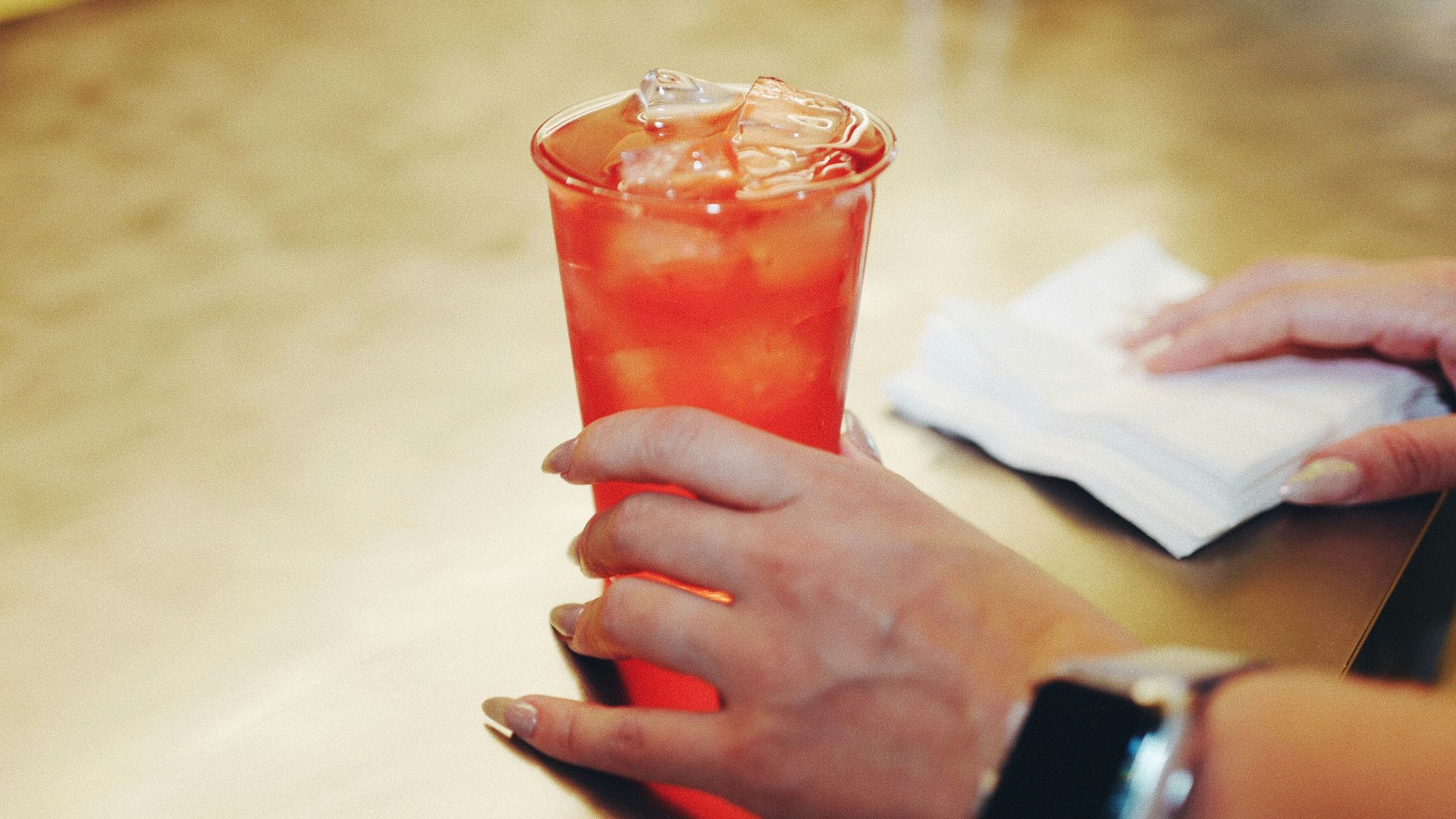 a close up of a person holding a drink