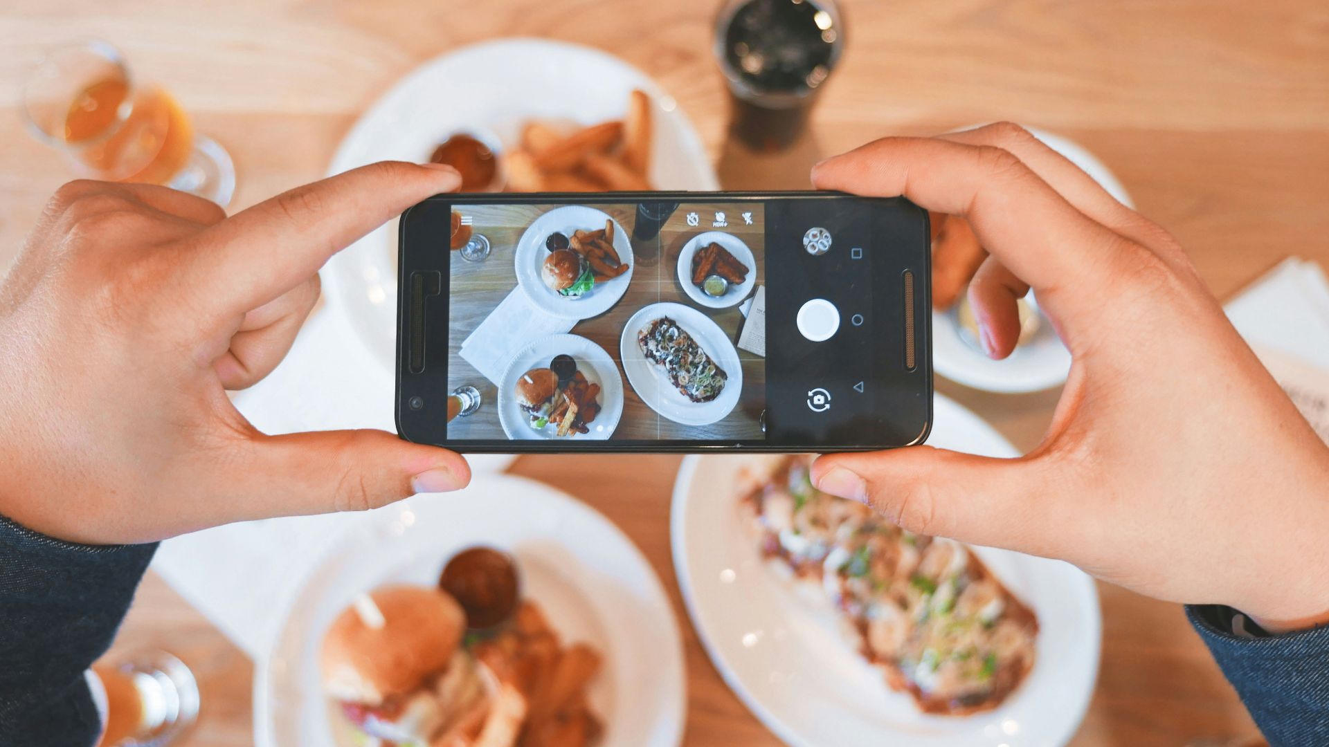person taking picture of the foods