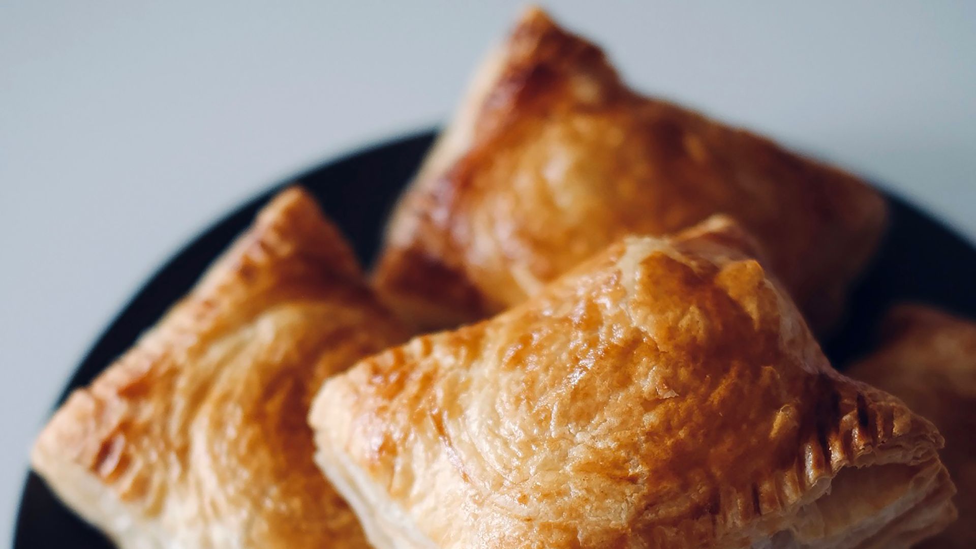a black plate topped with pastries on top of a table