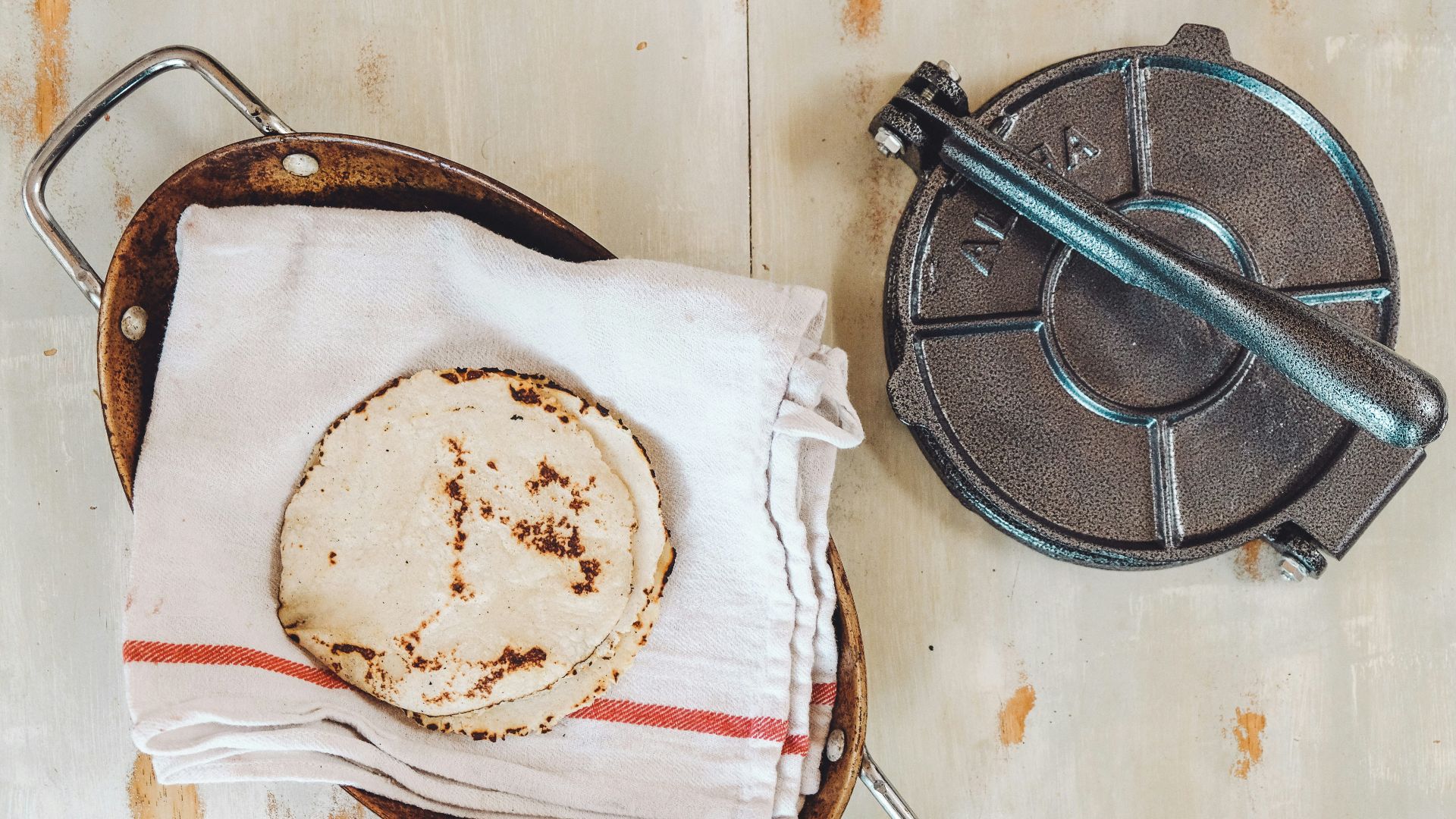 baked roti's on towel by roti maker