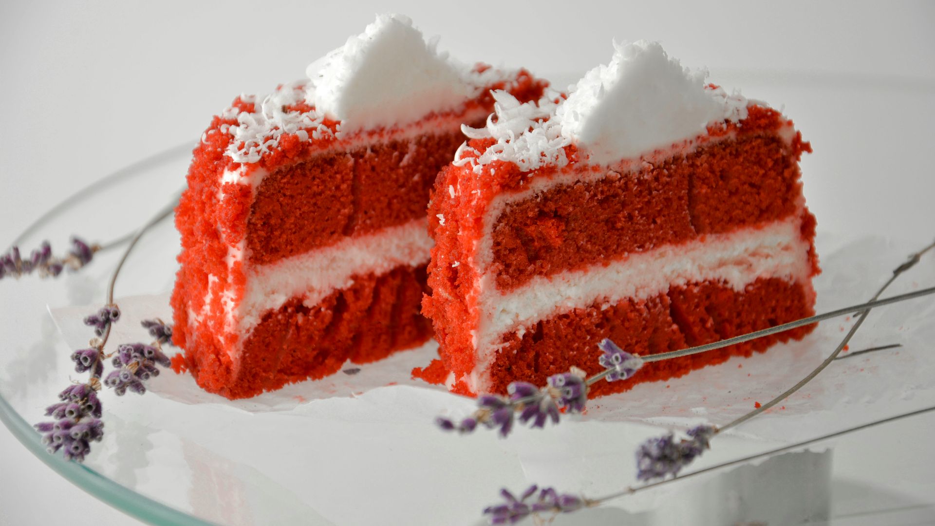 a piece of red velvet cake on a glass plate