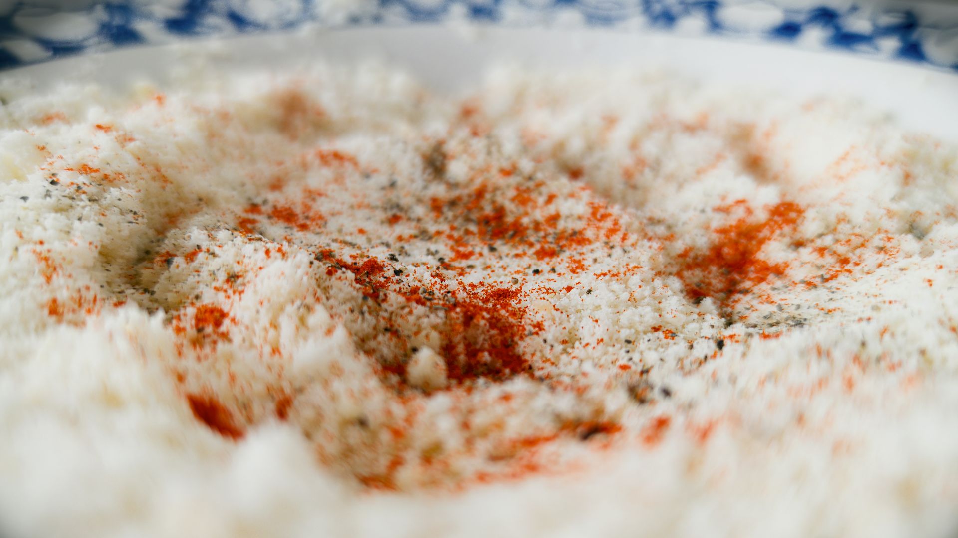 a bowl of rice with a red and white sprinkle