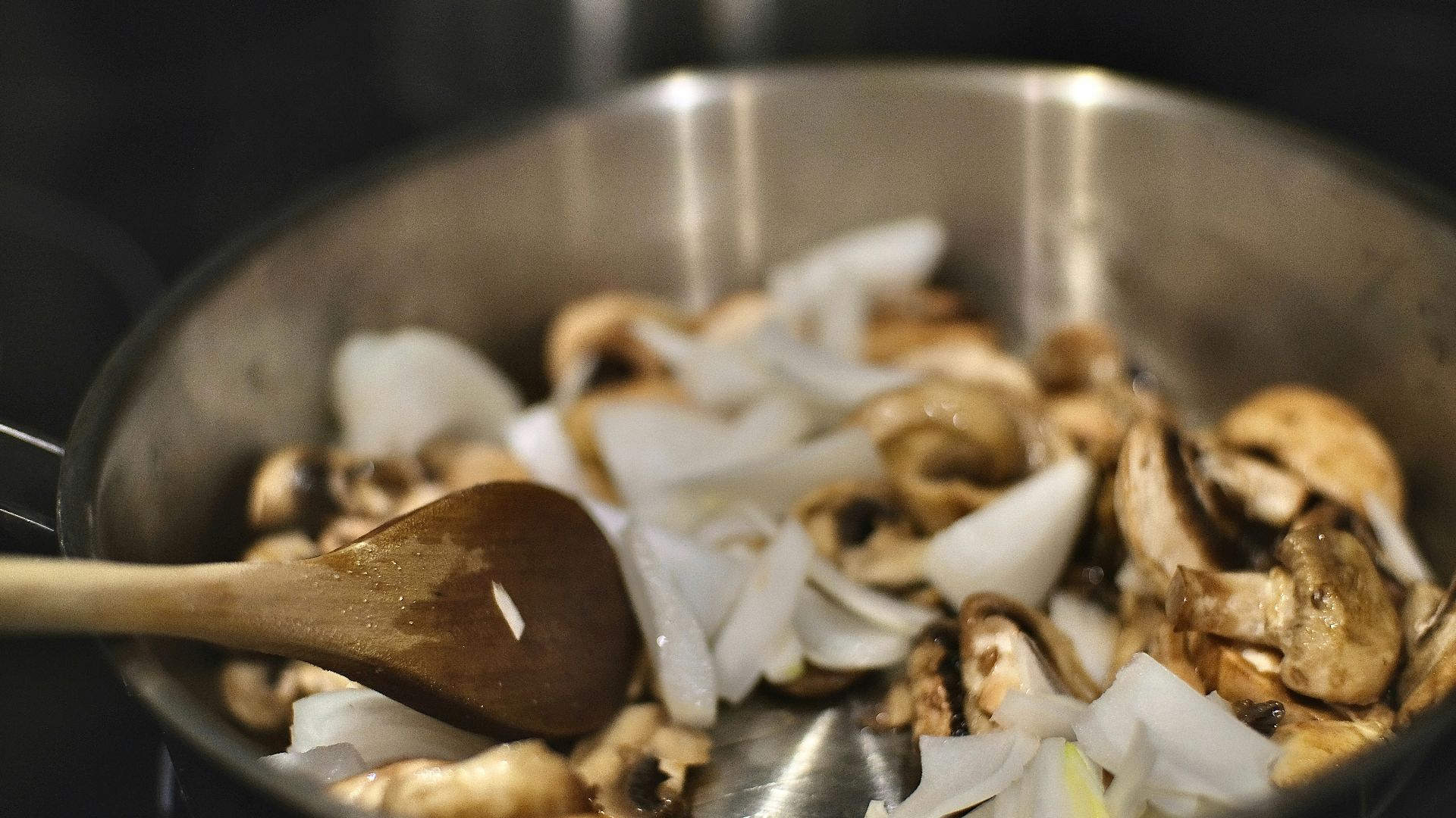 brown and white mushroom in stainless steel bowl