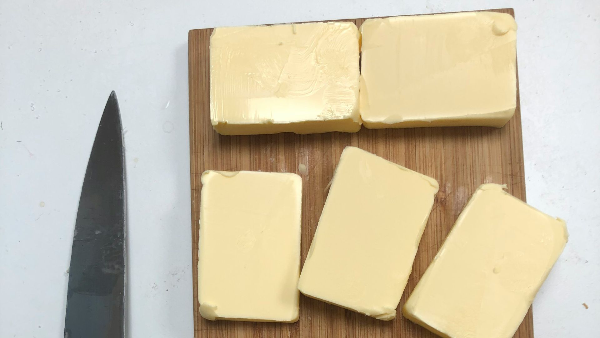 black handled knife beside cheese