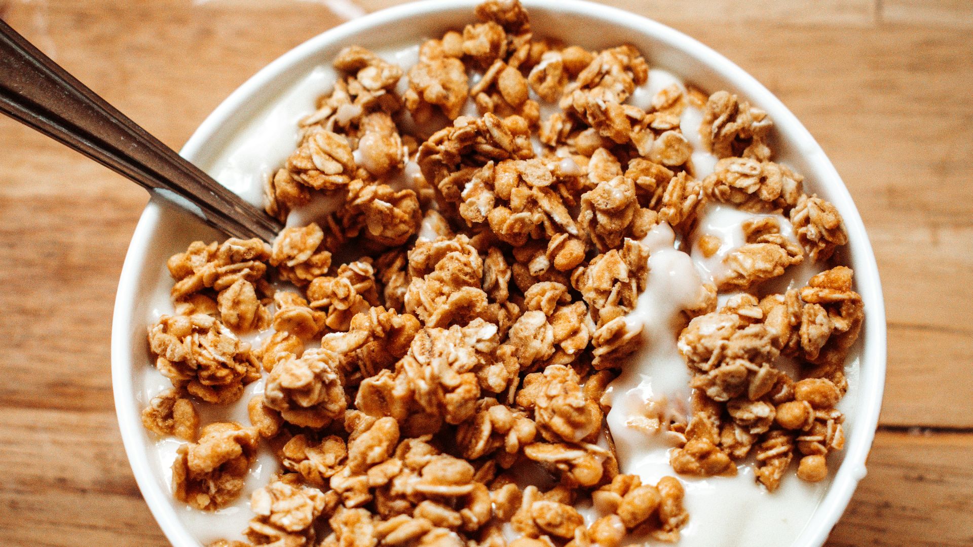 a bowl of granola on a wooden table