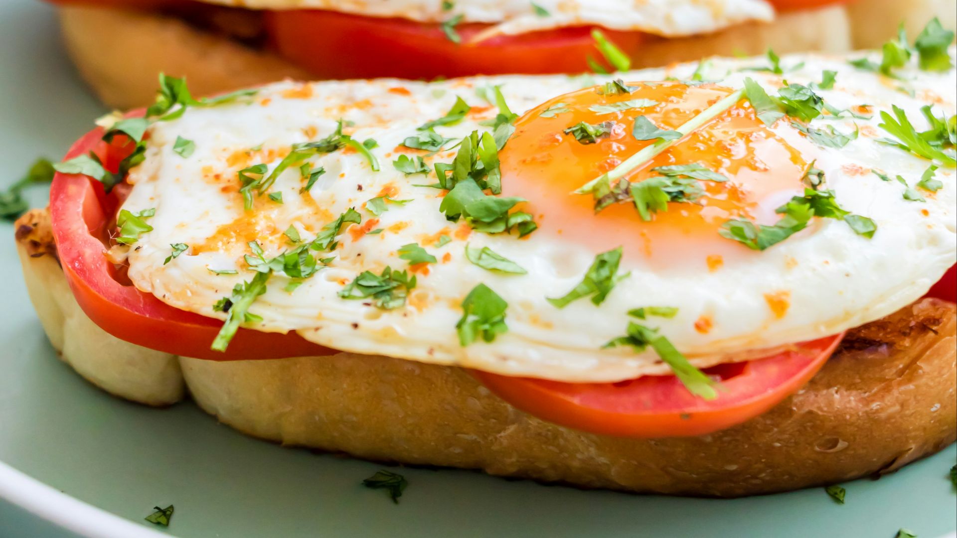 a plate of food with eggs and tomatoes on it
