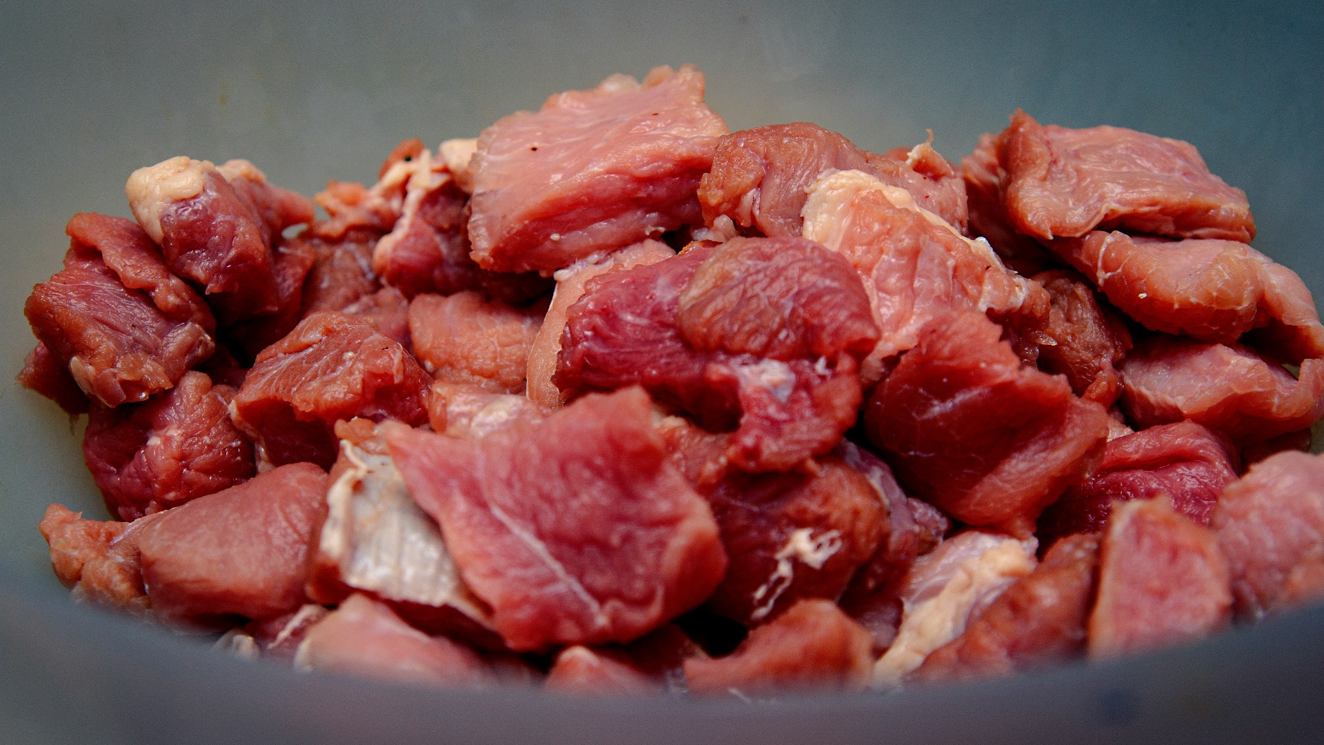 raw meat on blue ceramic bowl