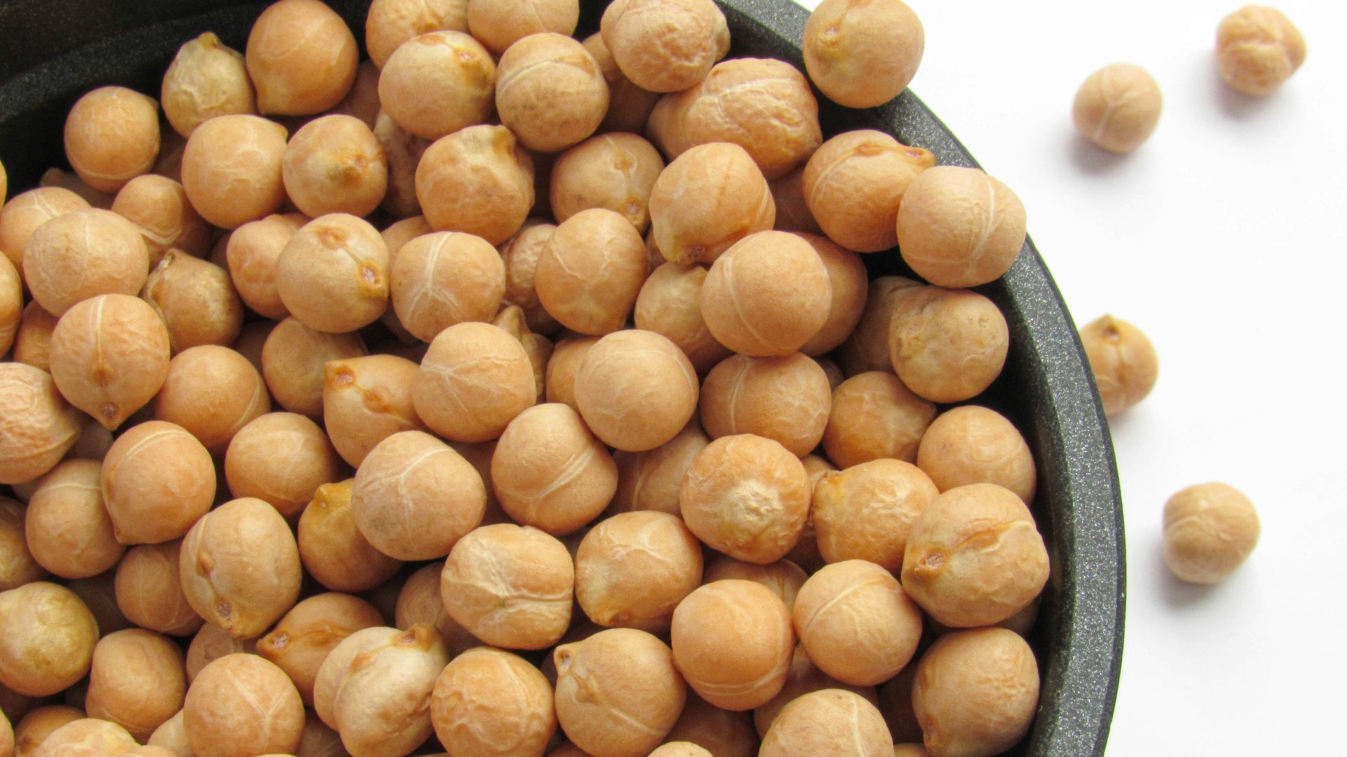 a bowl filled with chickpeas sitting on top of a table