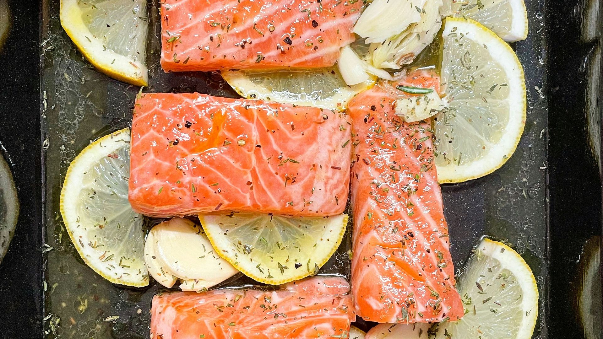 sliced fish meat on black plate