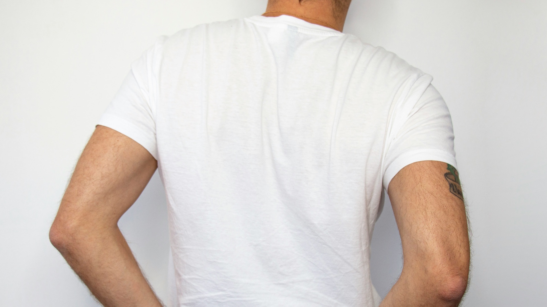 man holding his back pocket