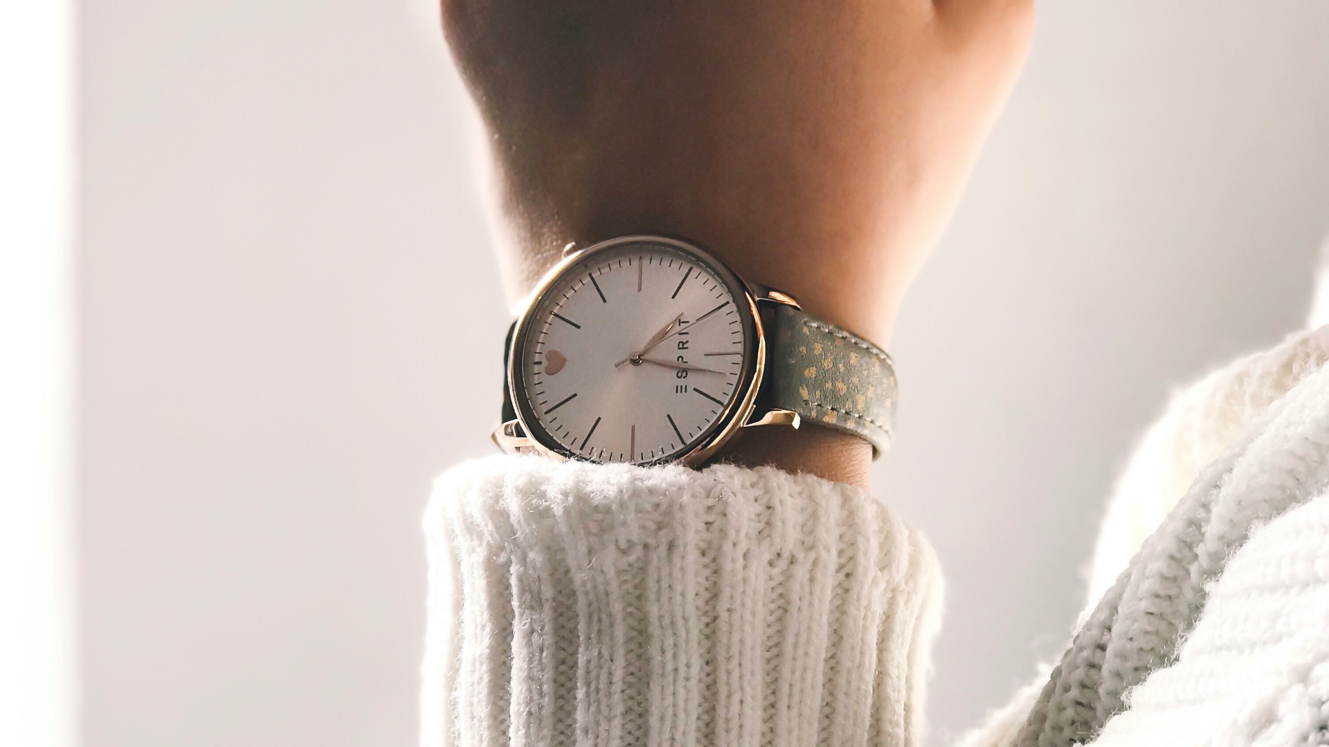 person wearing round silver-colored analog watch