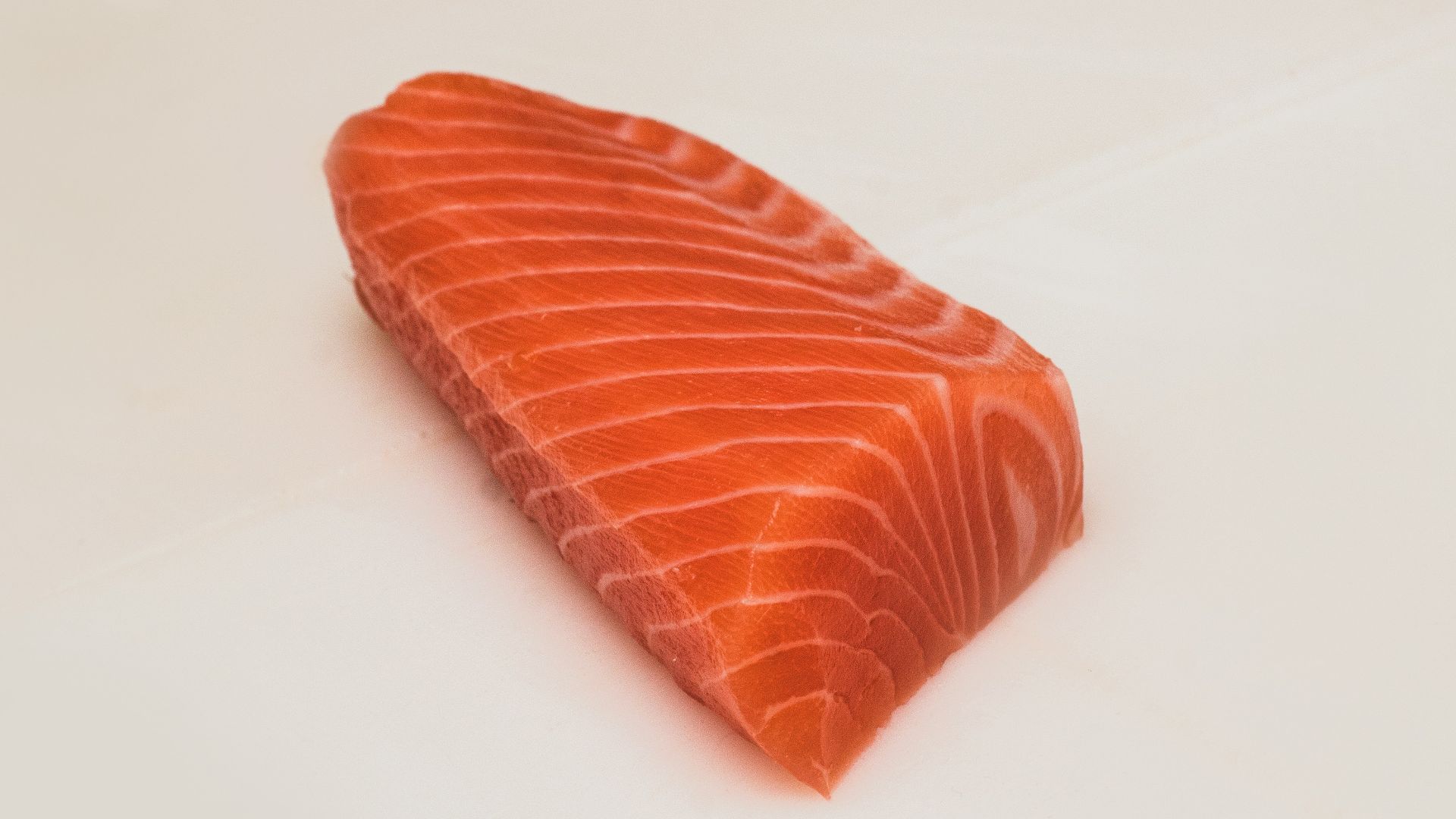 sliced fish meat on white surface