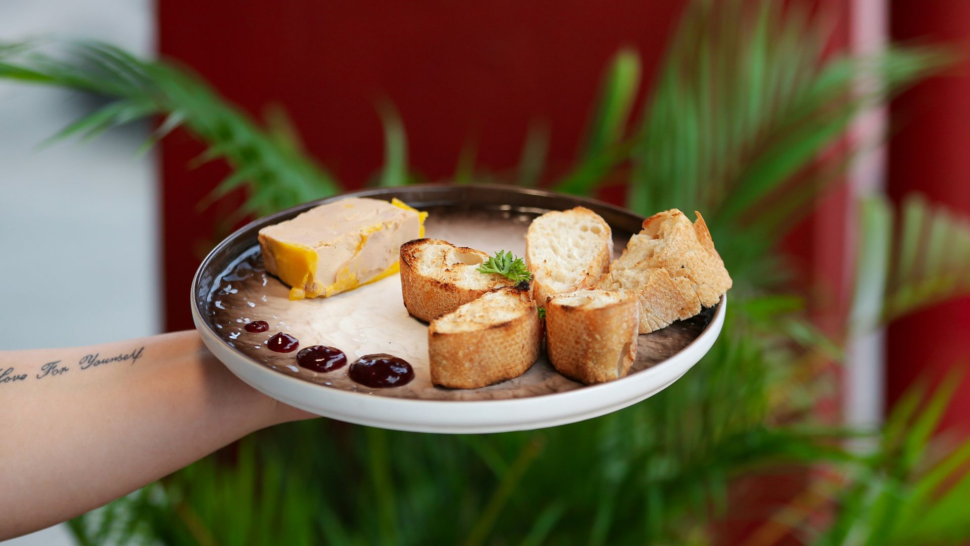a person holding a plate with food on it