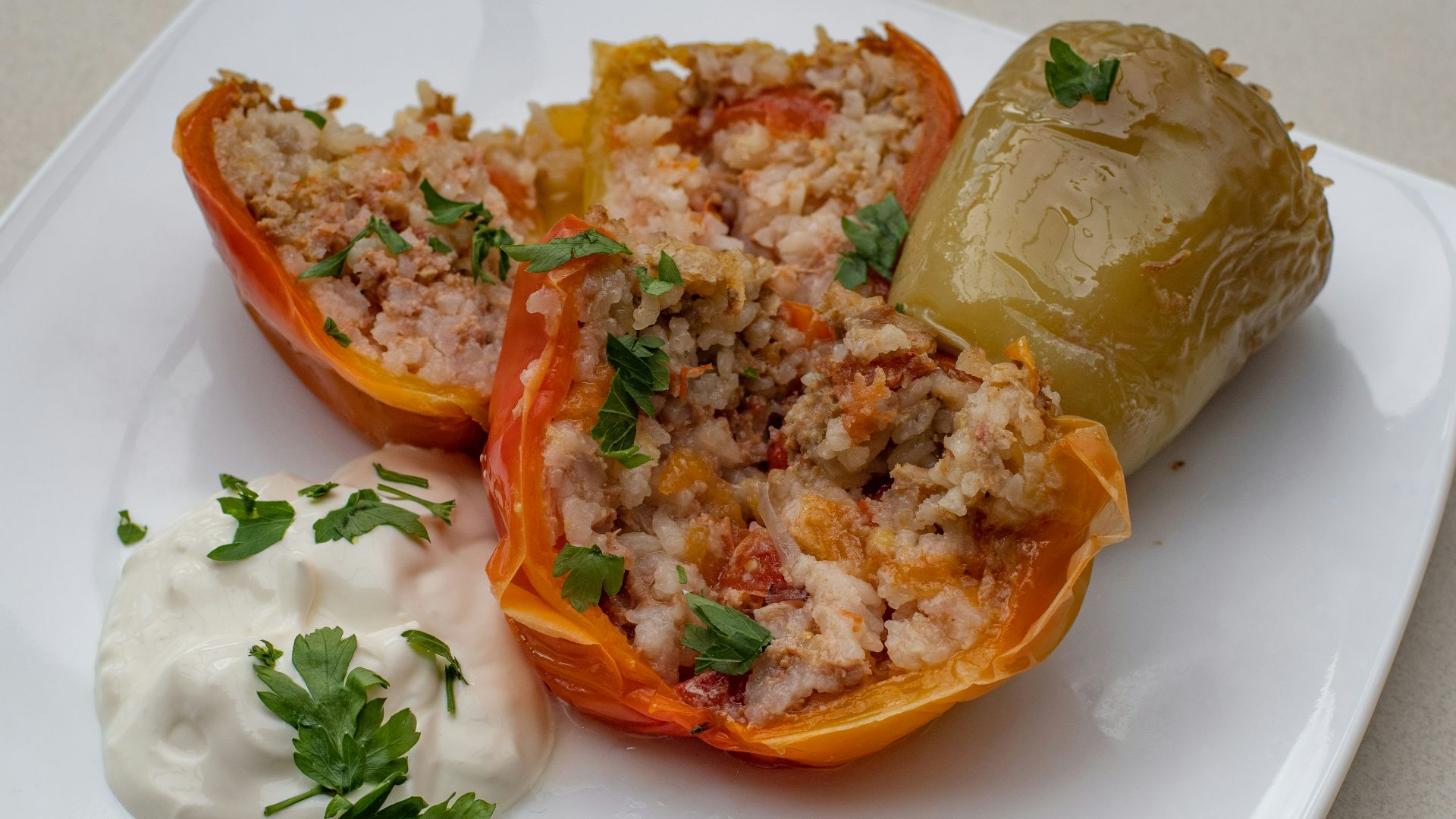 a white plate topped with stuffed bell peppers