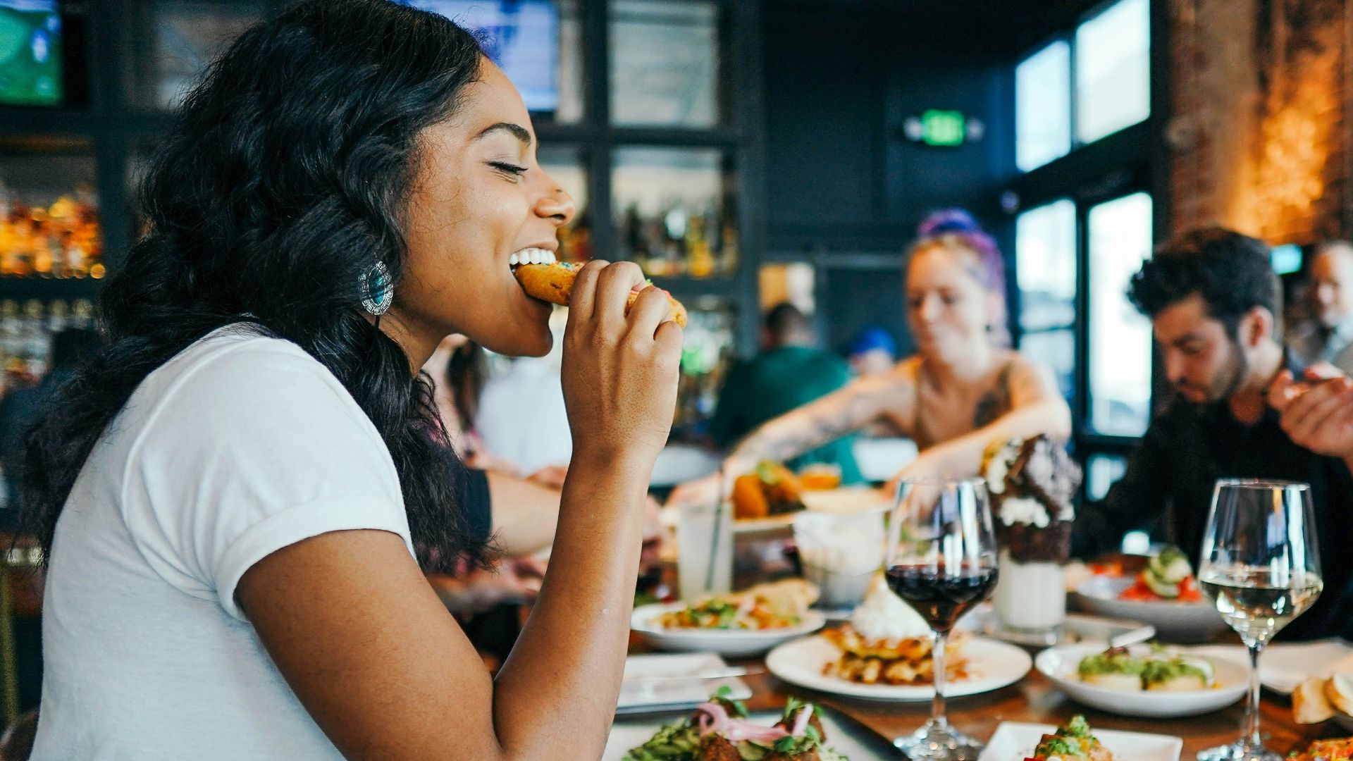 woman in white shirt eating