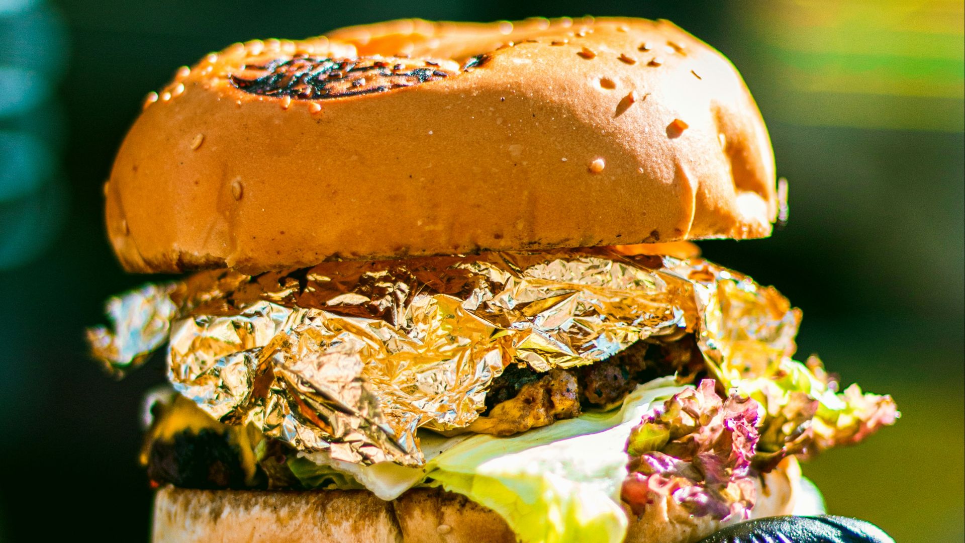 a person holding a sandwich in their hand