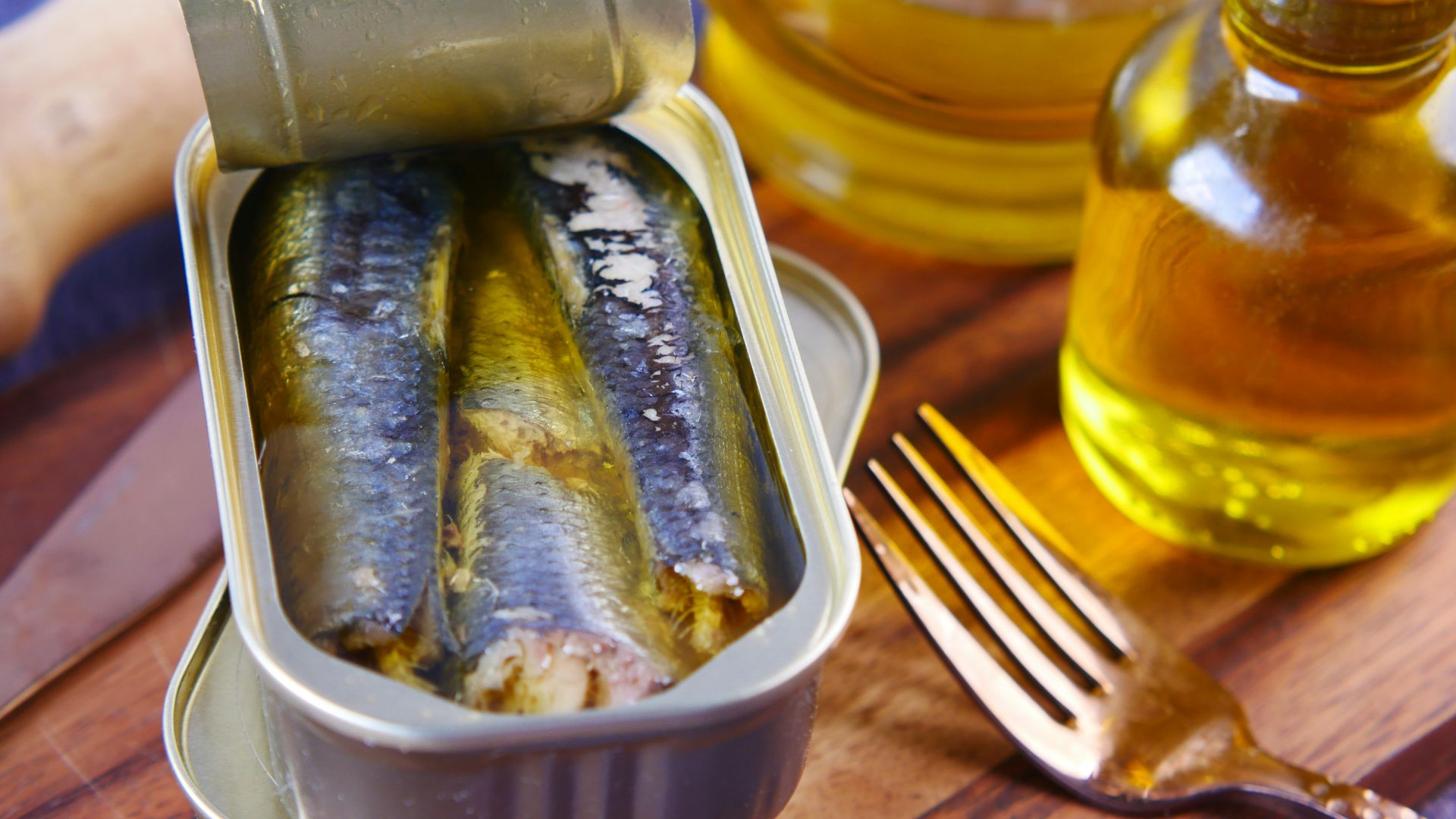 a tin of sardines sitting on top of a wooden table