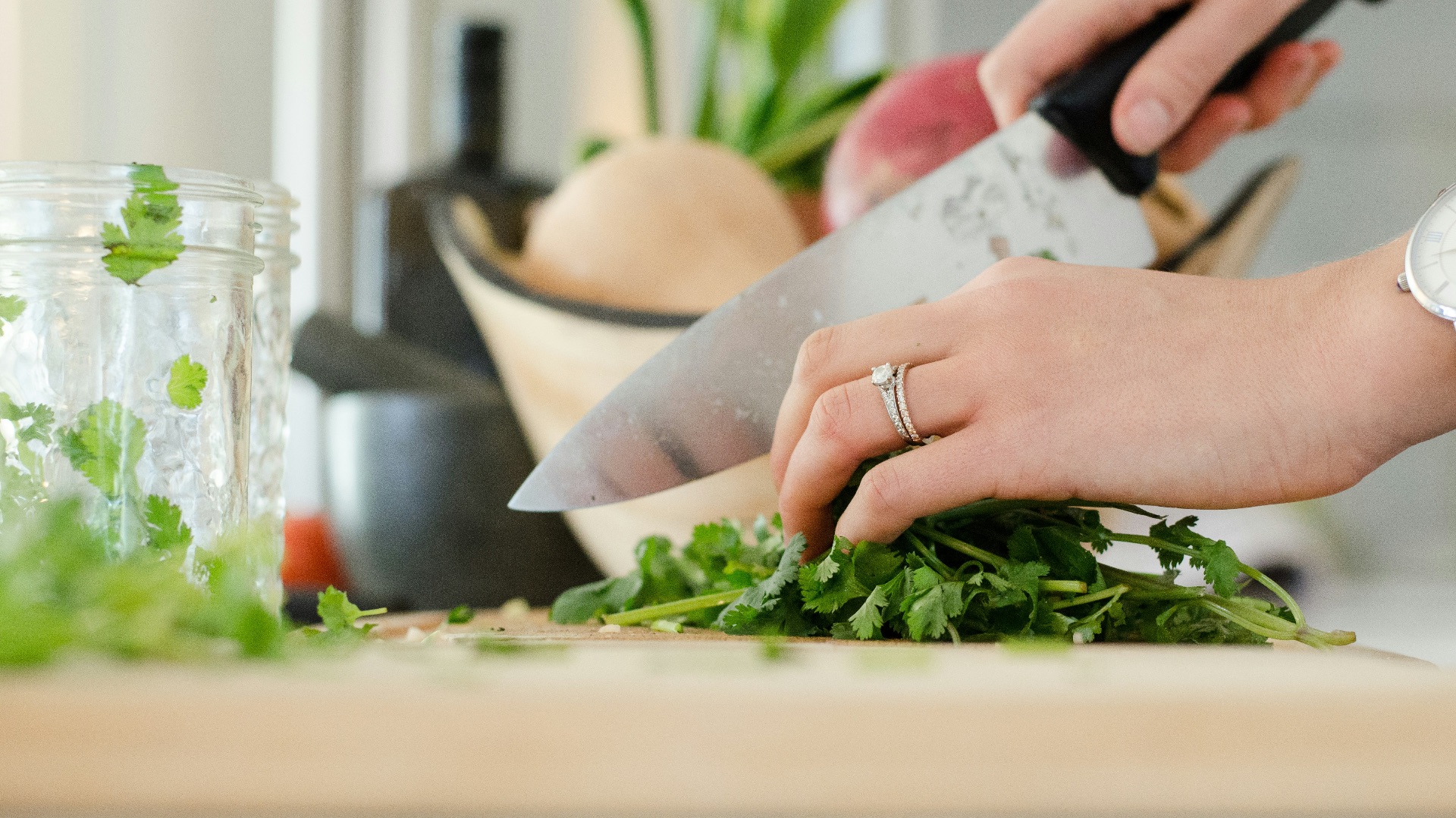 person cutting vegetables with knife