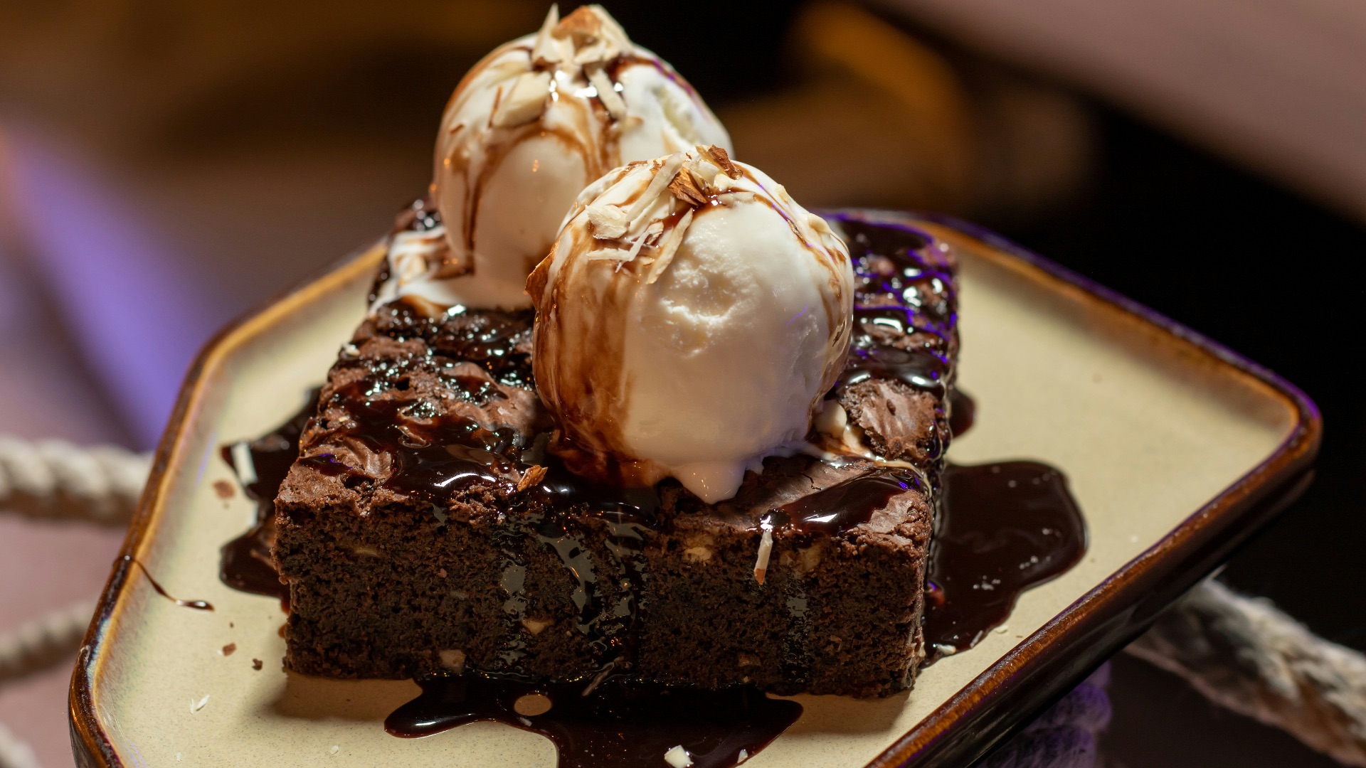 chocolate cake with white icing on white ceramic plate