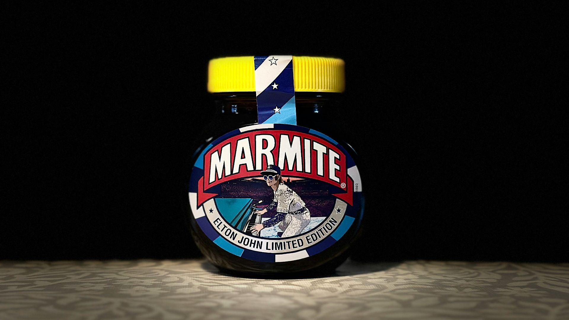 A jar of marmite sits on the floor