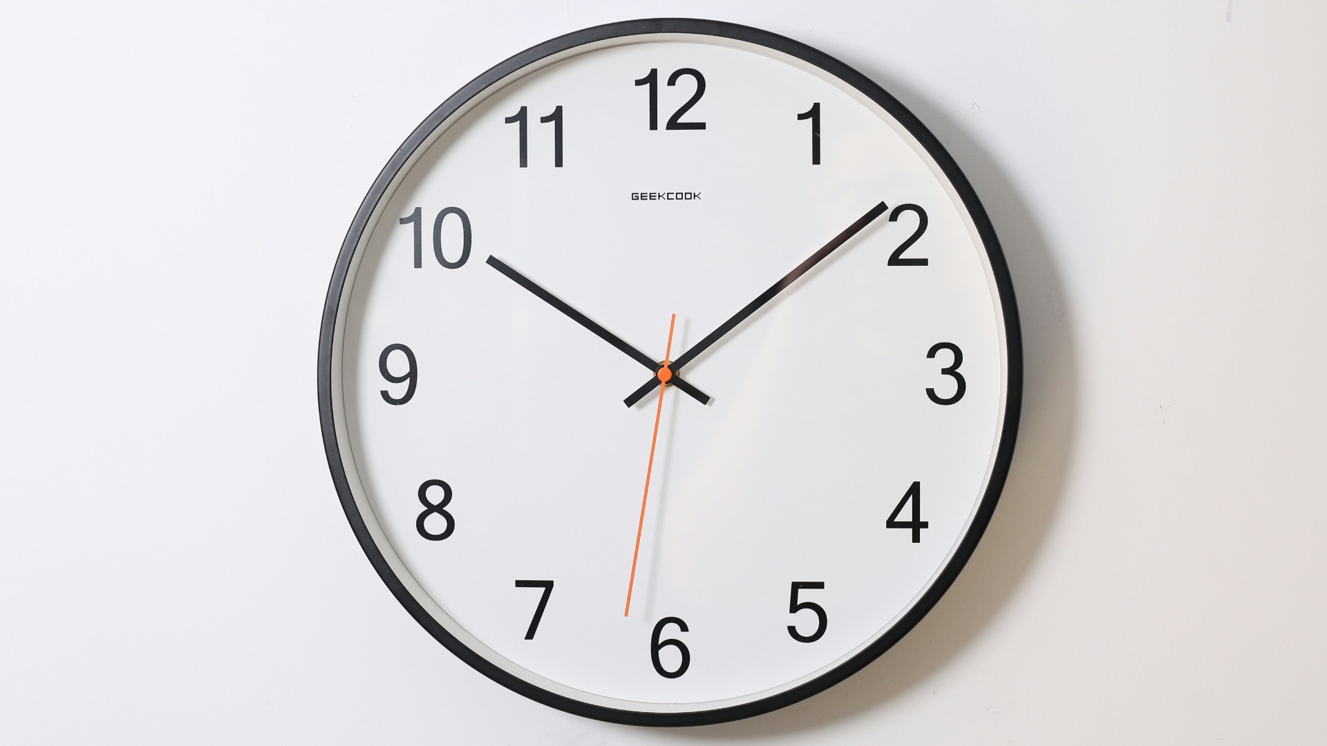 round analog wall clock pointing at 10:09