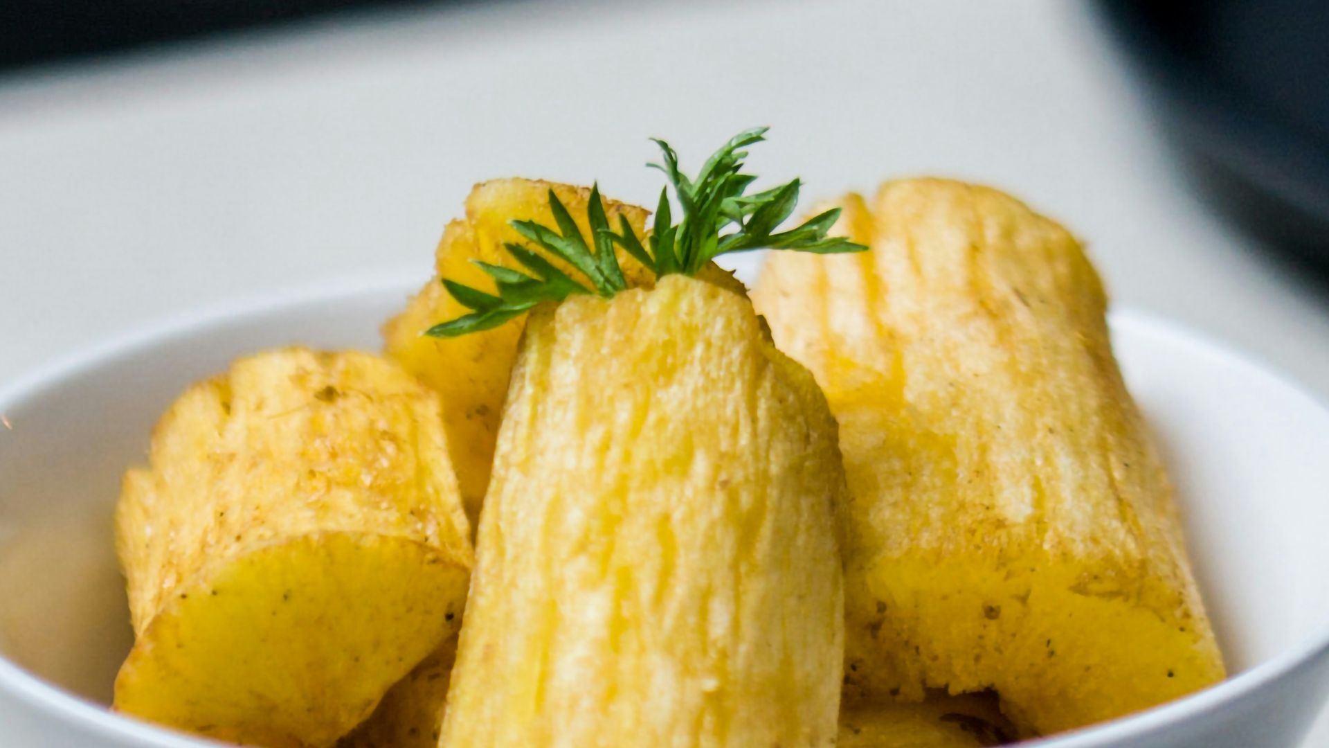 a white bowl filled with food on top of a table