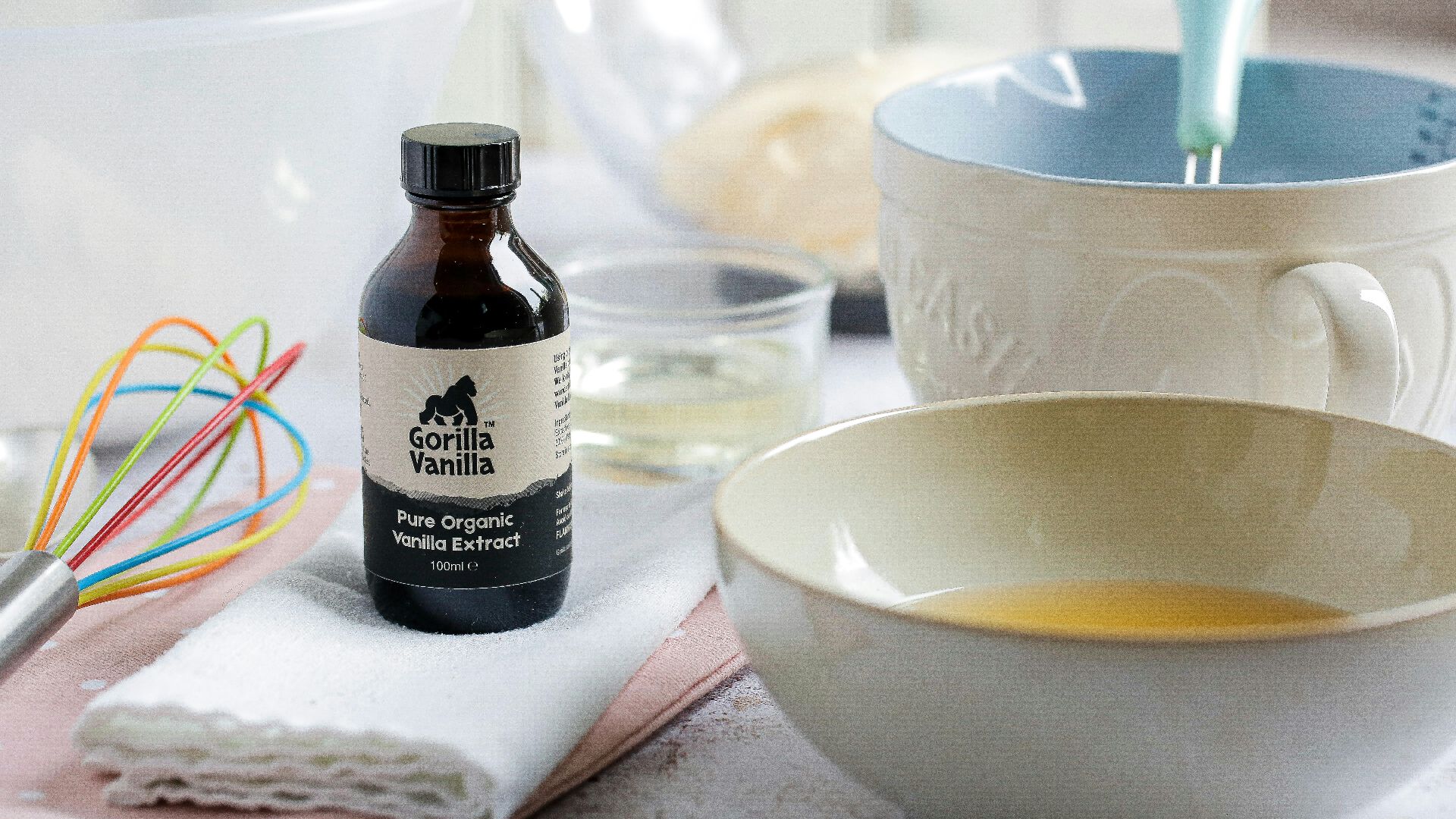 white ceramic bowl beside black glass bottle