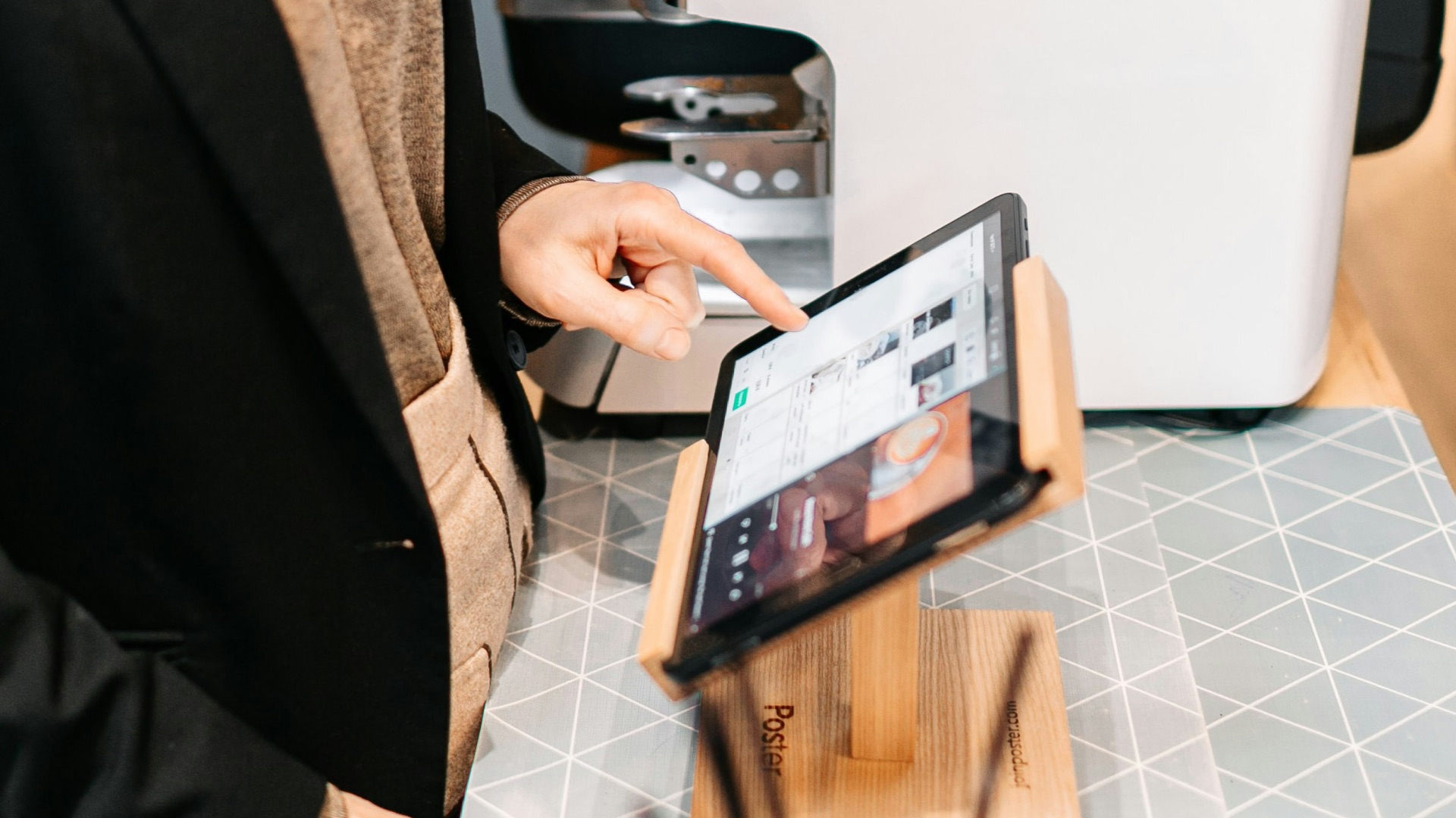 person in black blazer holding black ipad