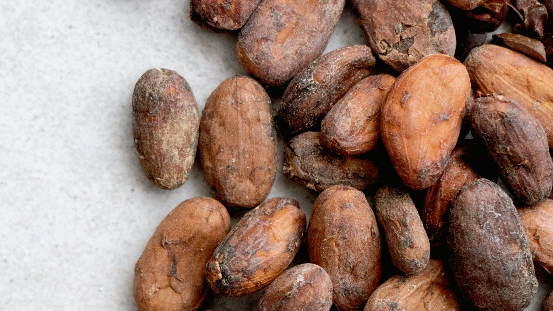 brown almond nuts on white surface