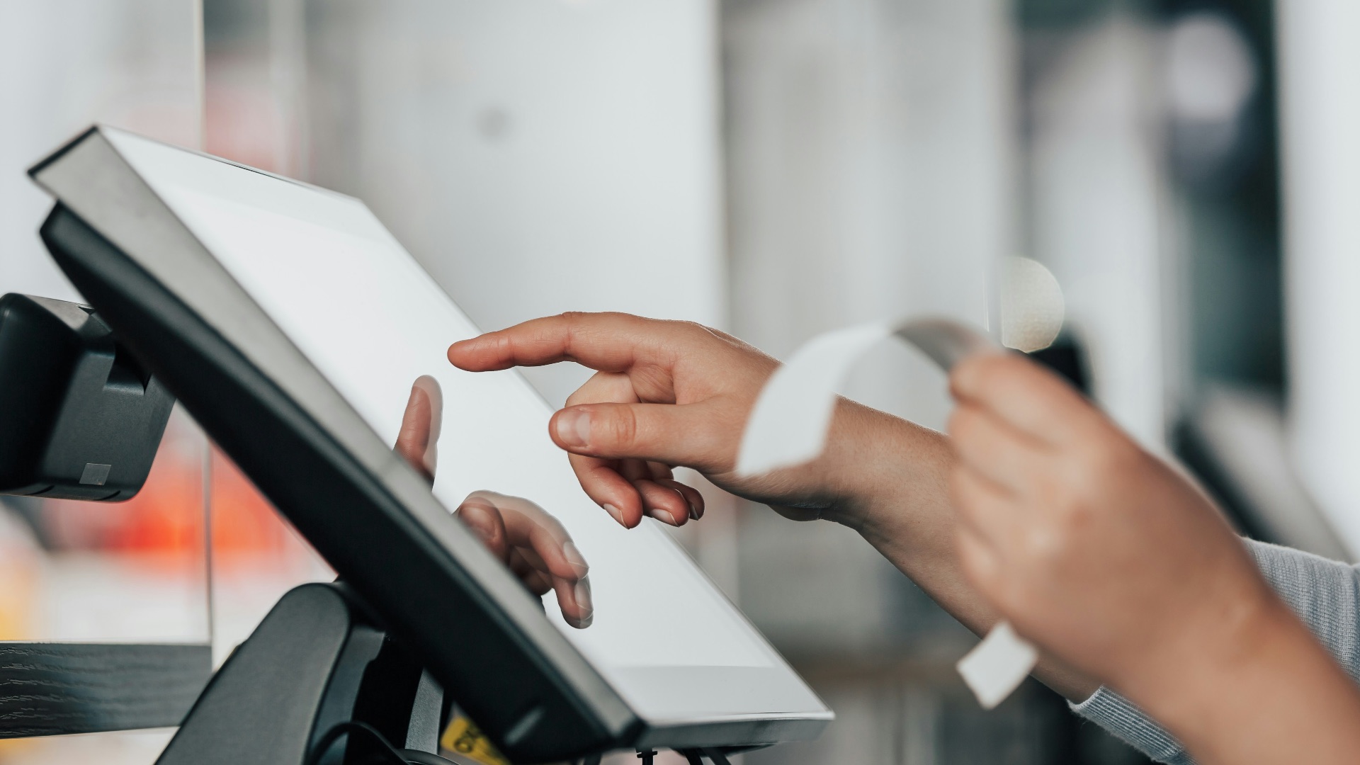 a person is using a pos machine in a store