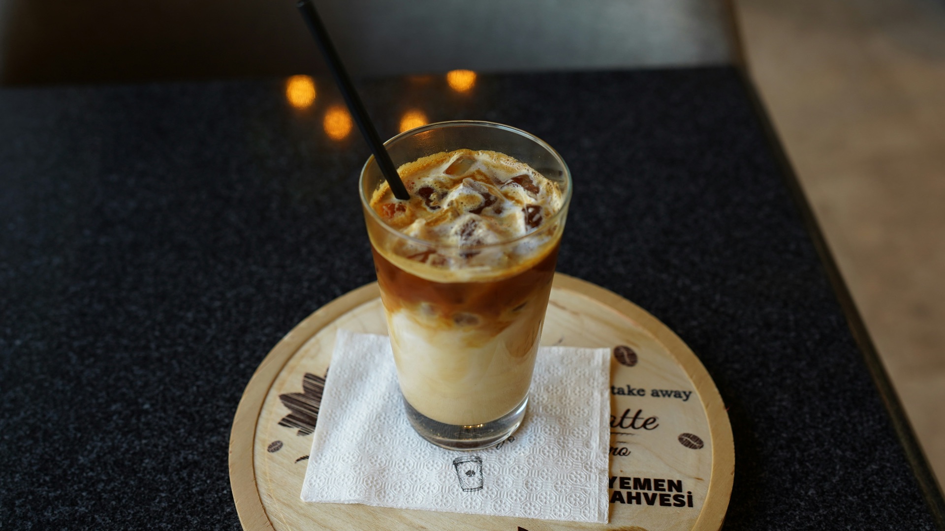 a glass of liquid with a straw