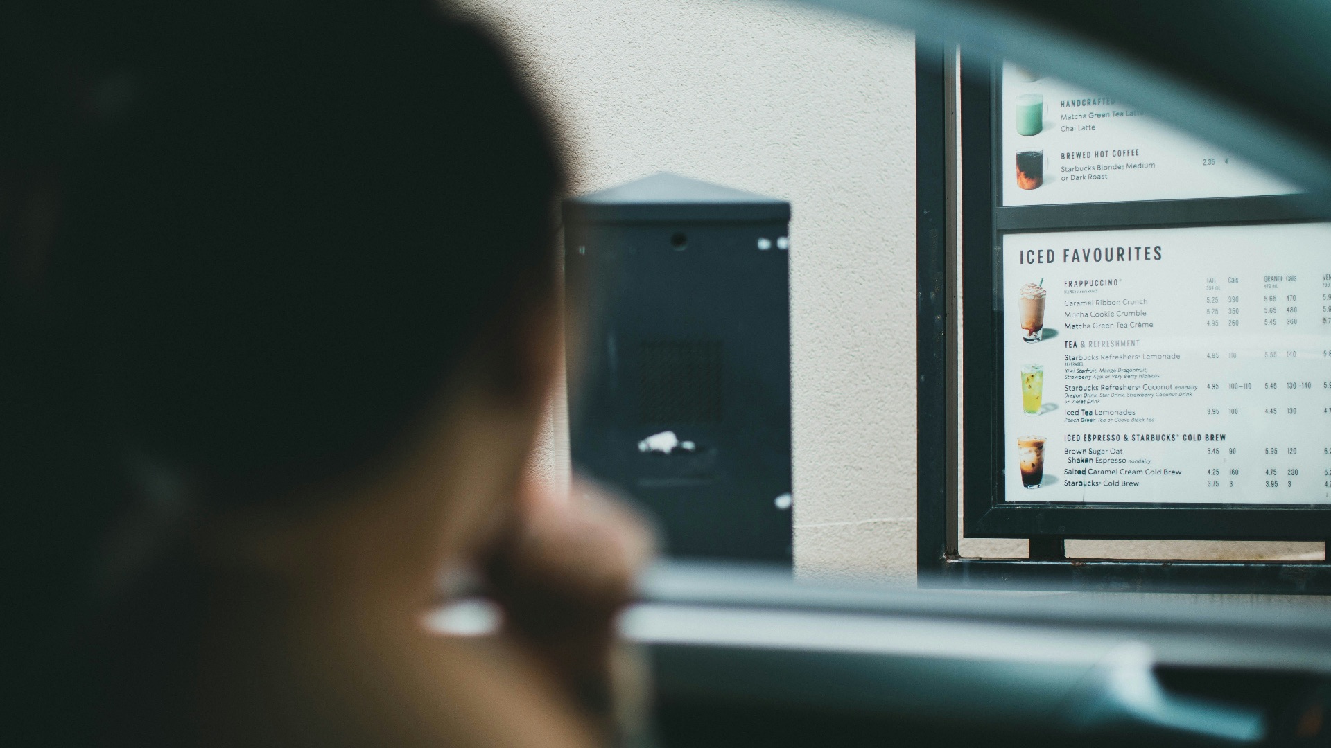person holding black smartphone in car