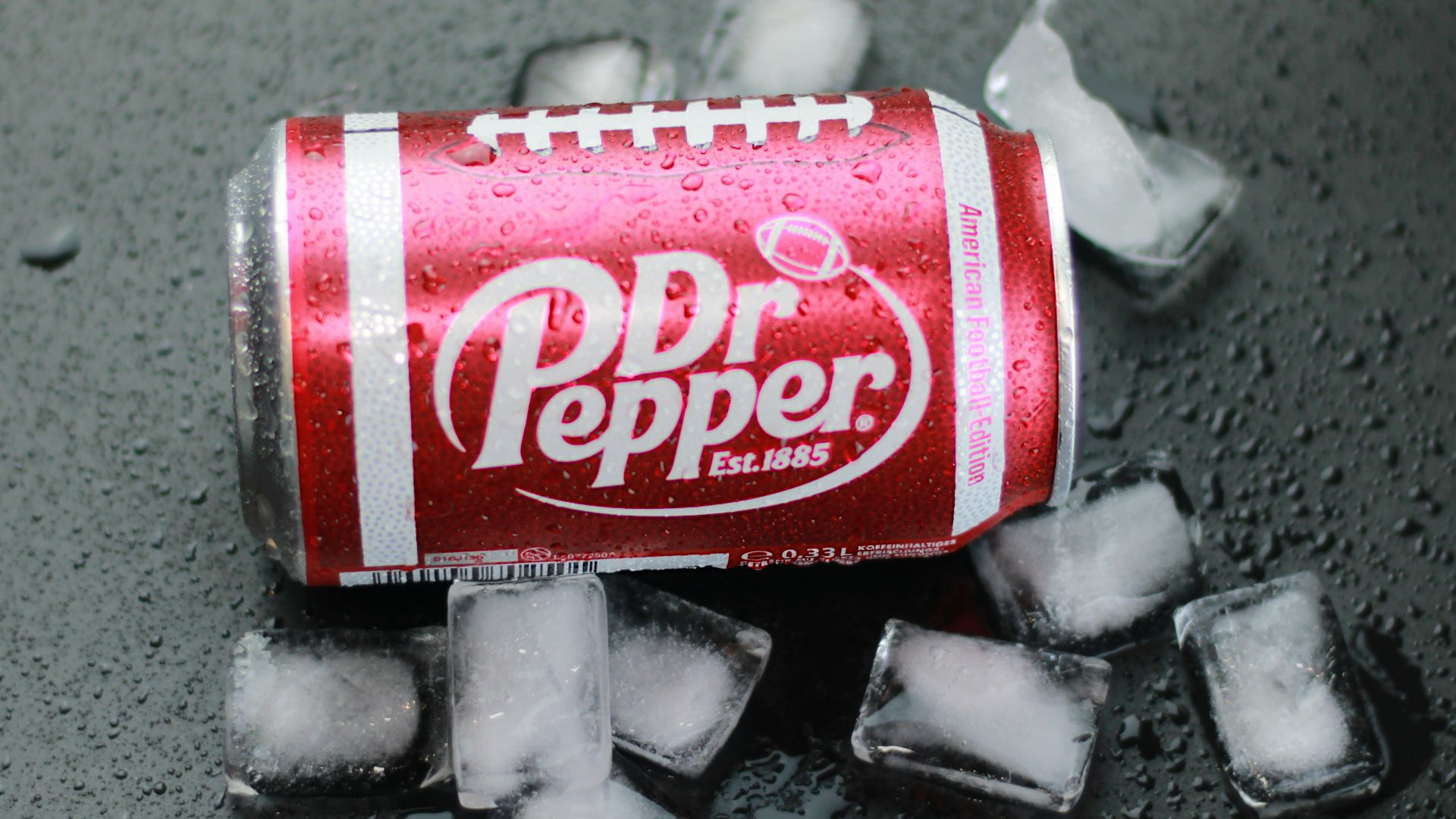 a can of soda sitting on top of ice cubes