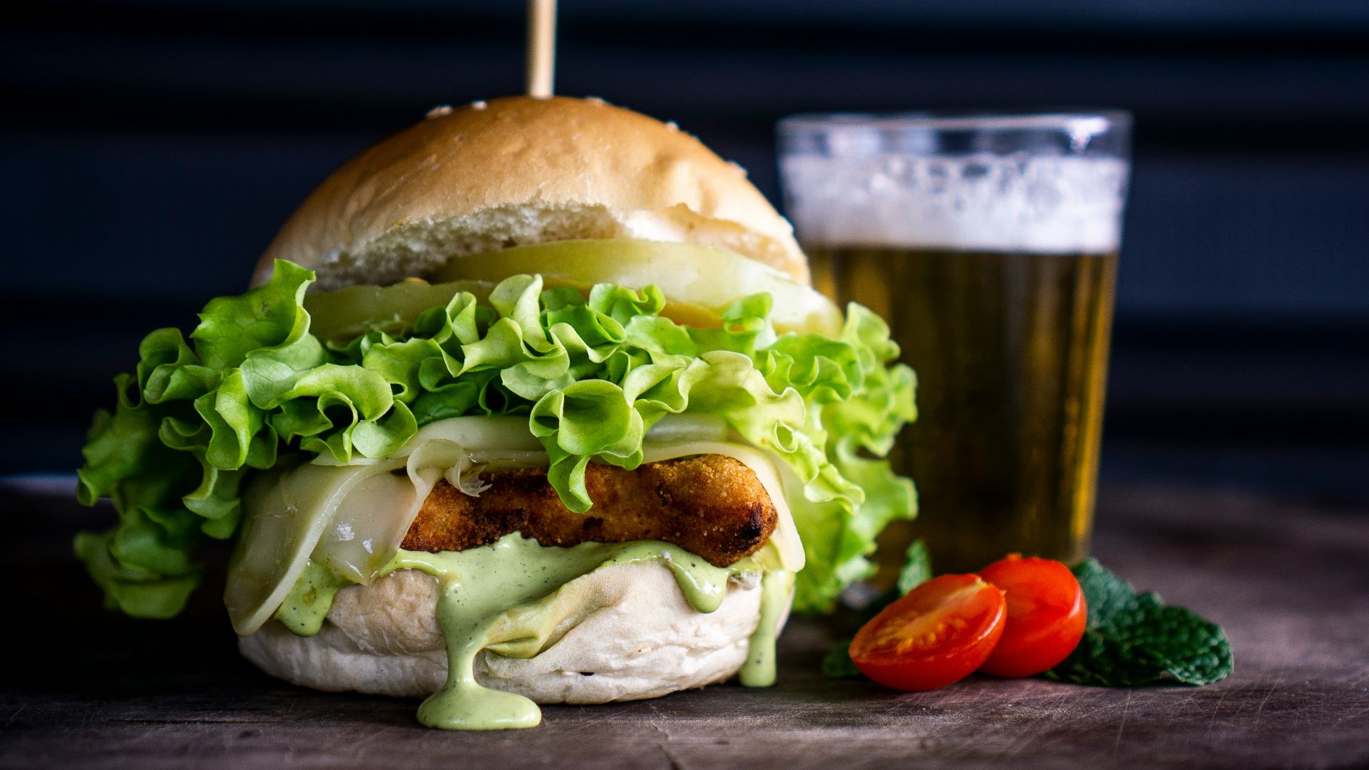 burger with sliced vegetable and white cream close-up photography