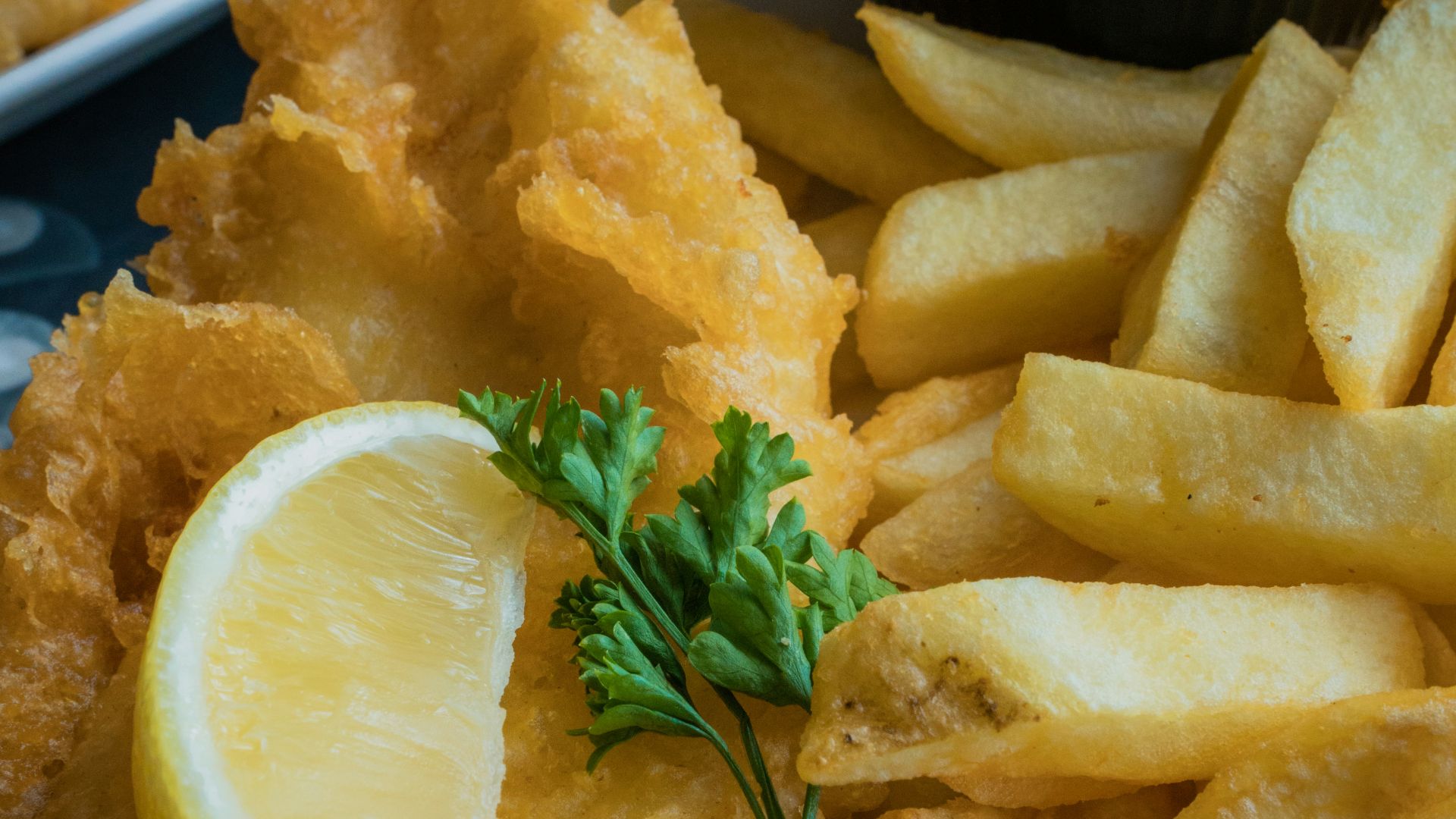 a white plate topped with fried fish and fries